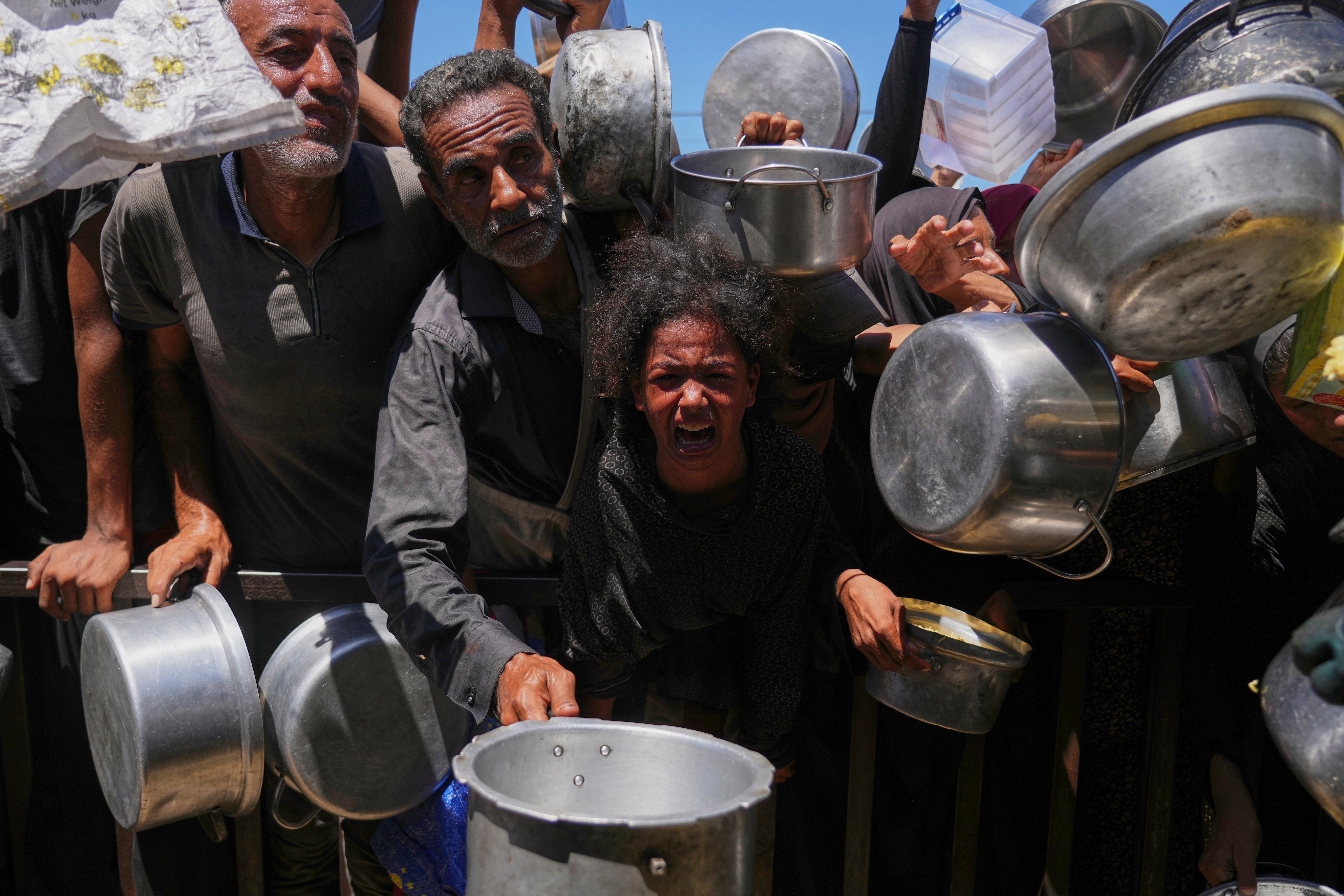 Palestinians struggle to get donated food in the Gaza Strip’s Khan Younis. Photo: AP