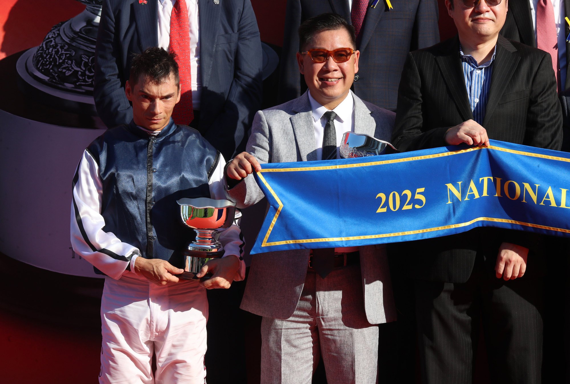 Jockey Alexis Badel and trainer Dennis Yip celebrate Fast Network’s career-best triumph.