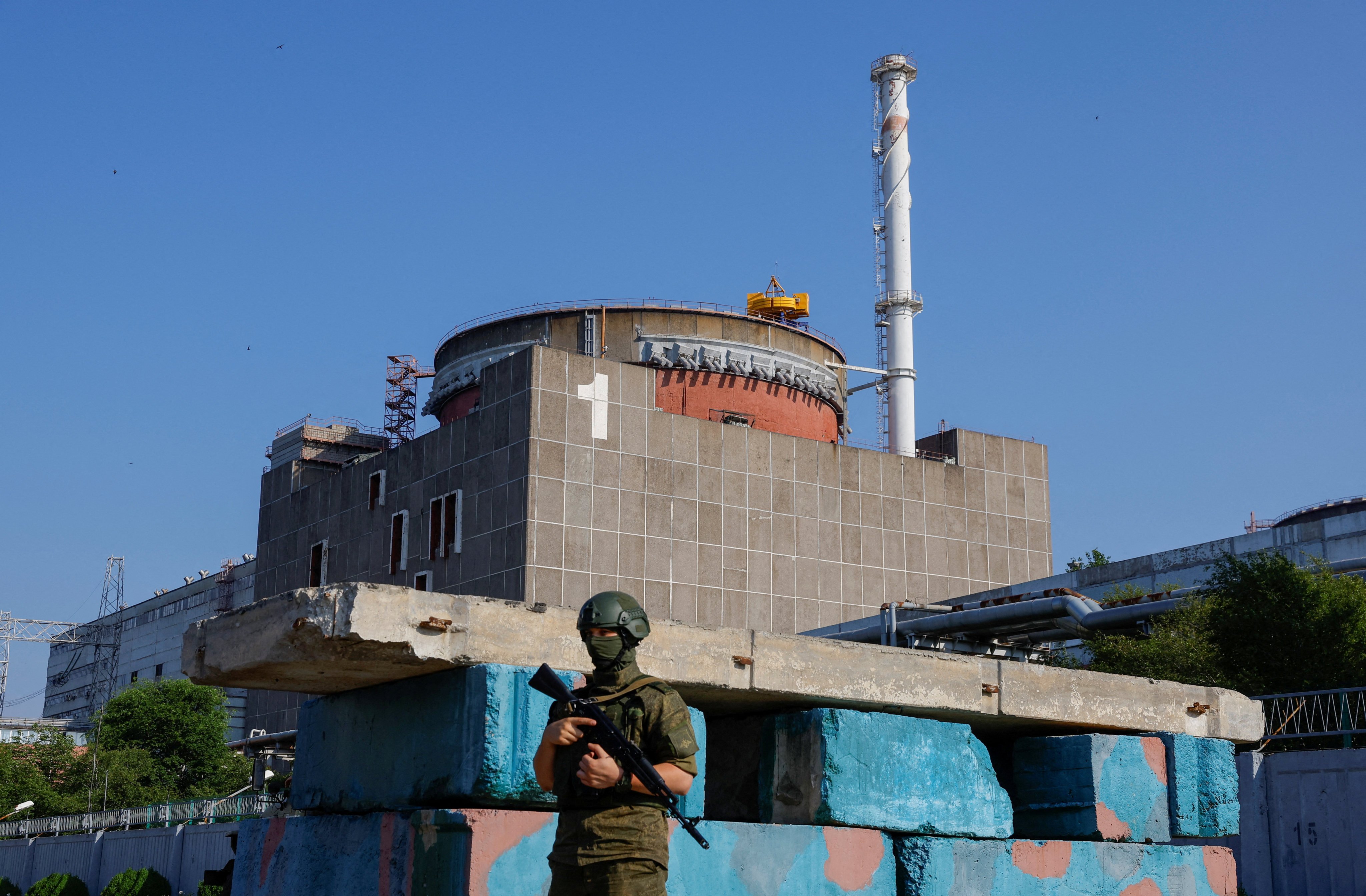 A Russian service member stands guard at a checkpoint near the Zaporizhzhia nuclear power plant in June 2023. Photo: Reuters