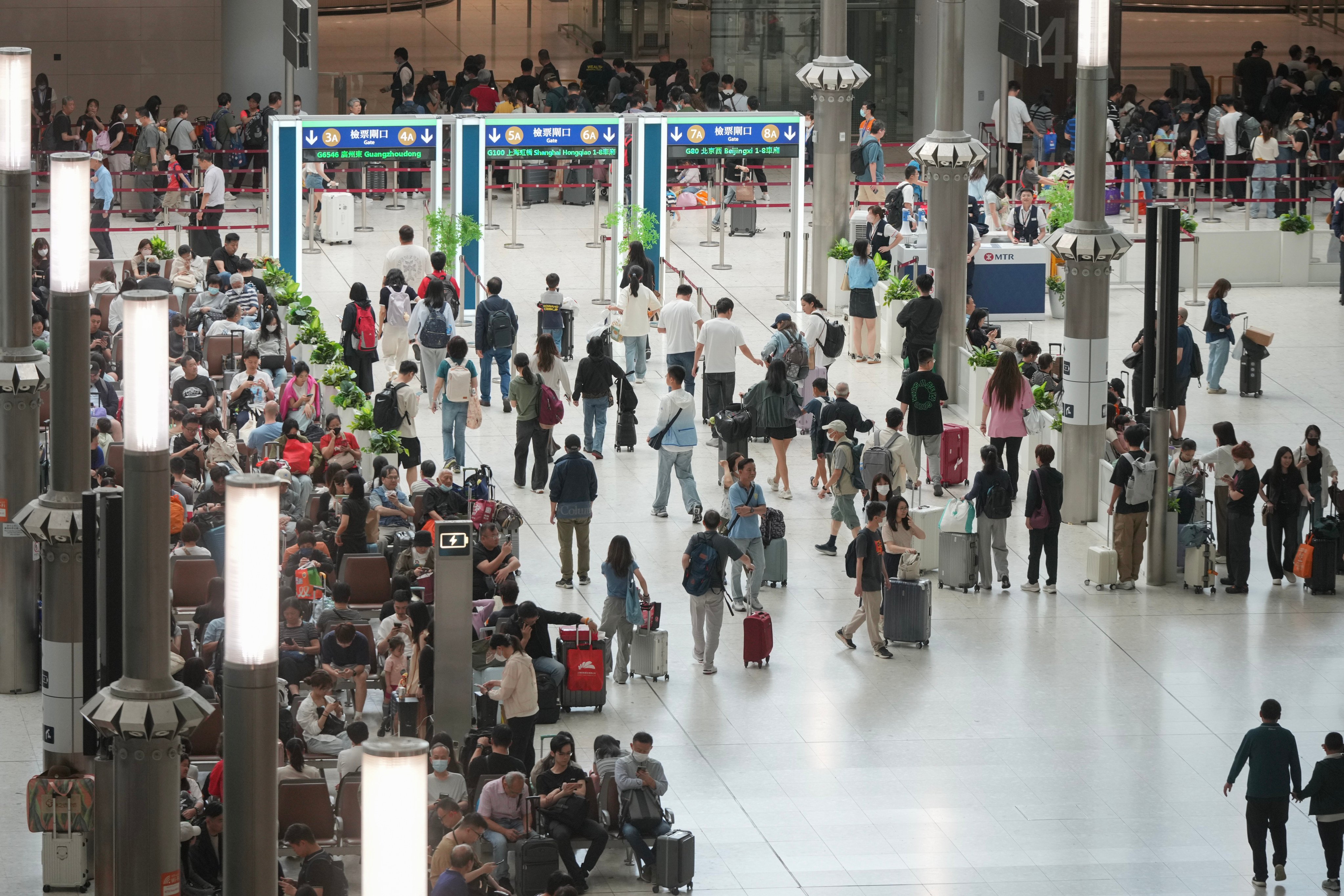 Travelers depart Hong Kong from the West Kowloon Express Railway Station on May 1, 2025. Photo: May Tse
