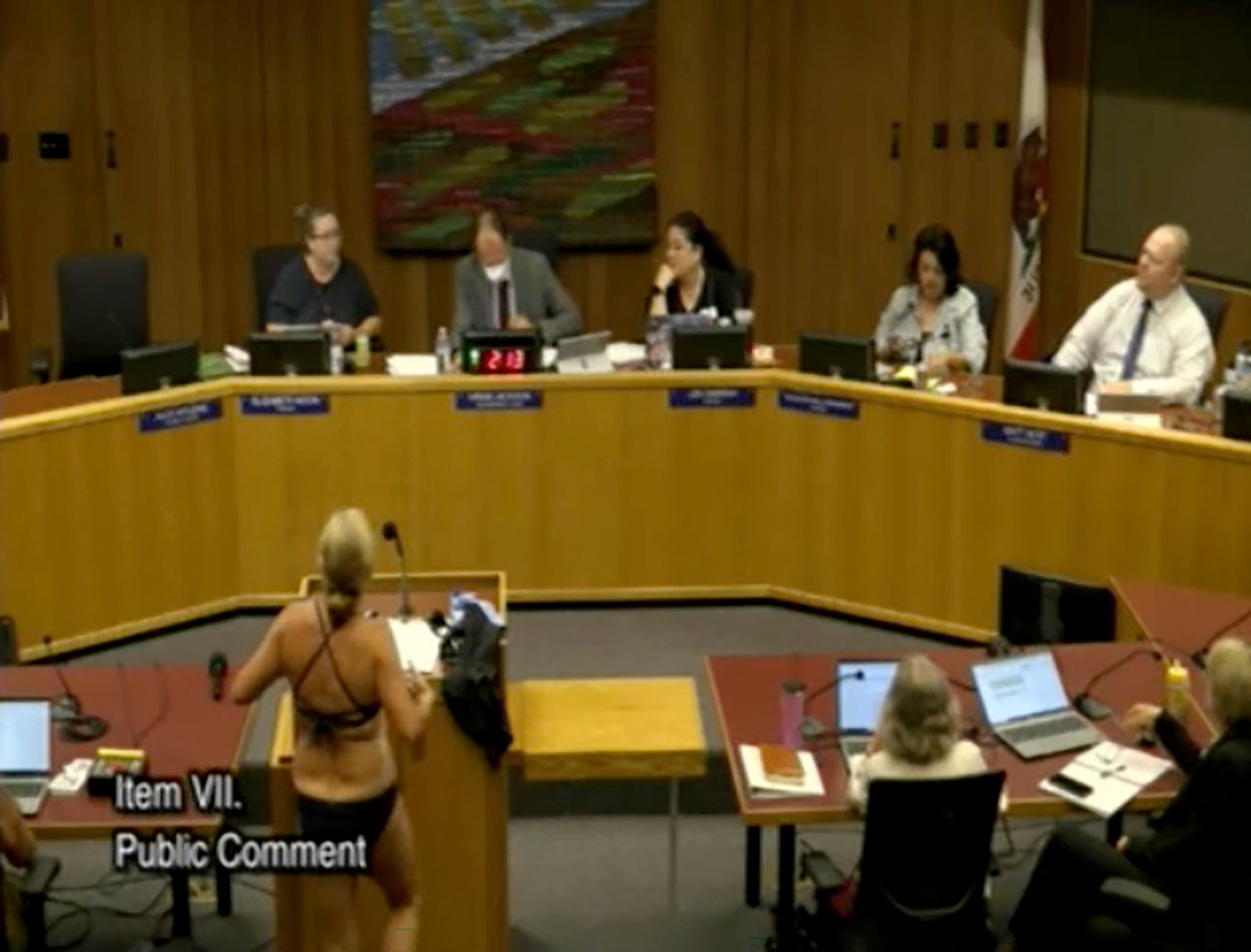Beth Bourne removes her clothes at the Sept. 18, 2025, Davis Joint Unified School District board meeting in protest of the district’s bathroom and locker room policies. (Davis Joint Unified School District/TNS)