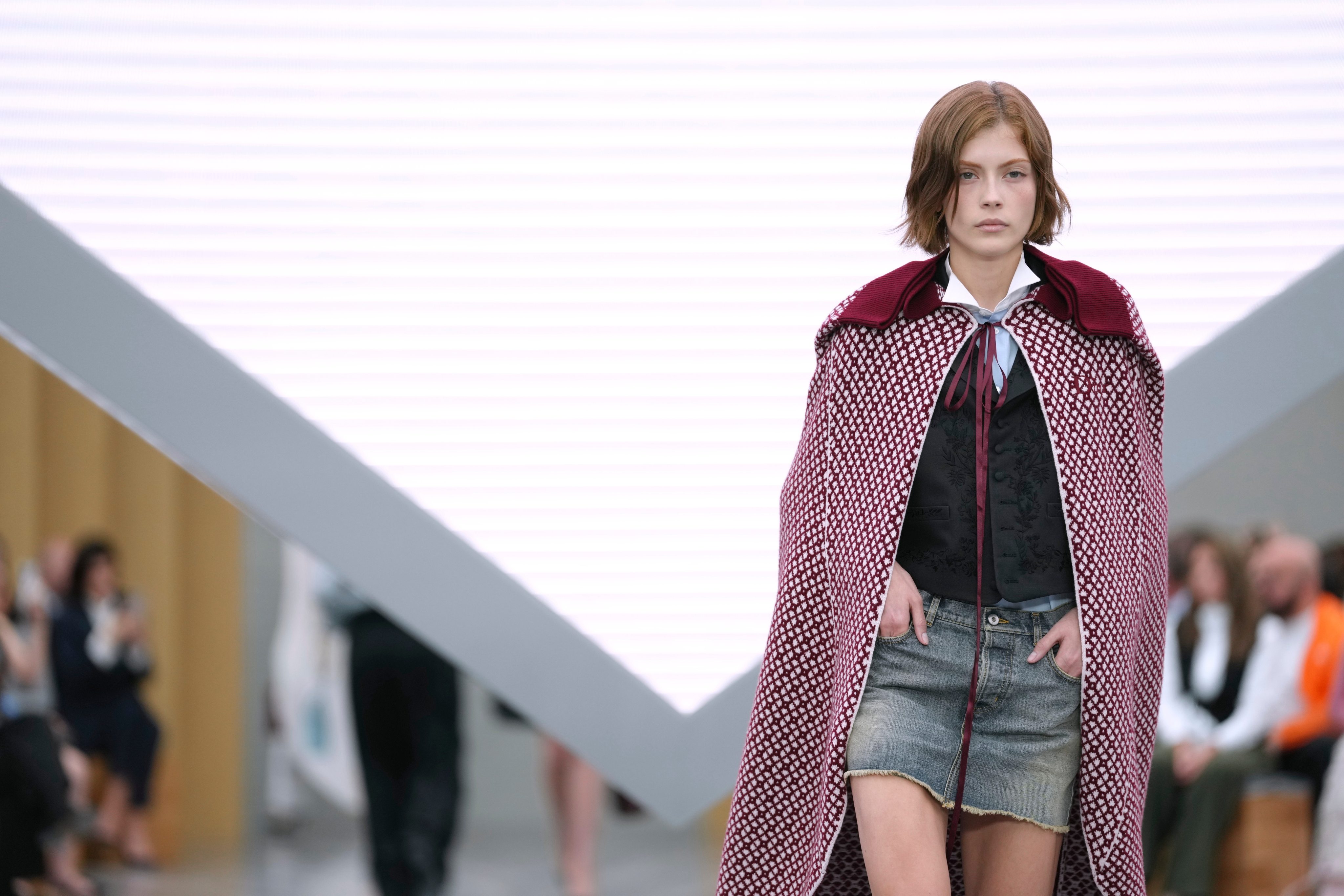 A cape paired with a denim miniskirt at Dior’s spring/summer 2026 show. Photo: AP