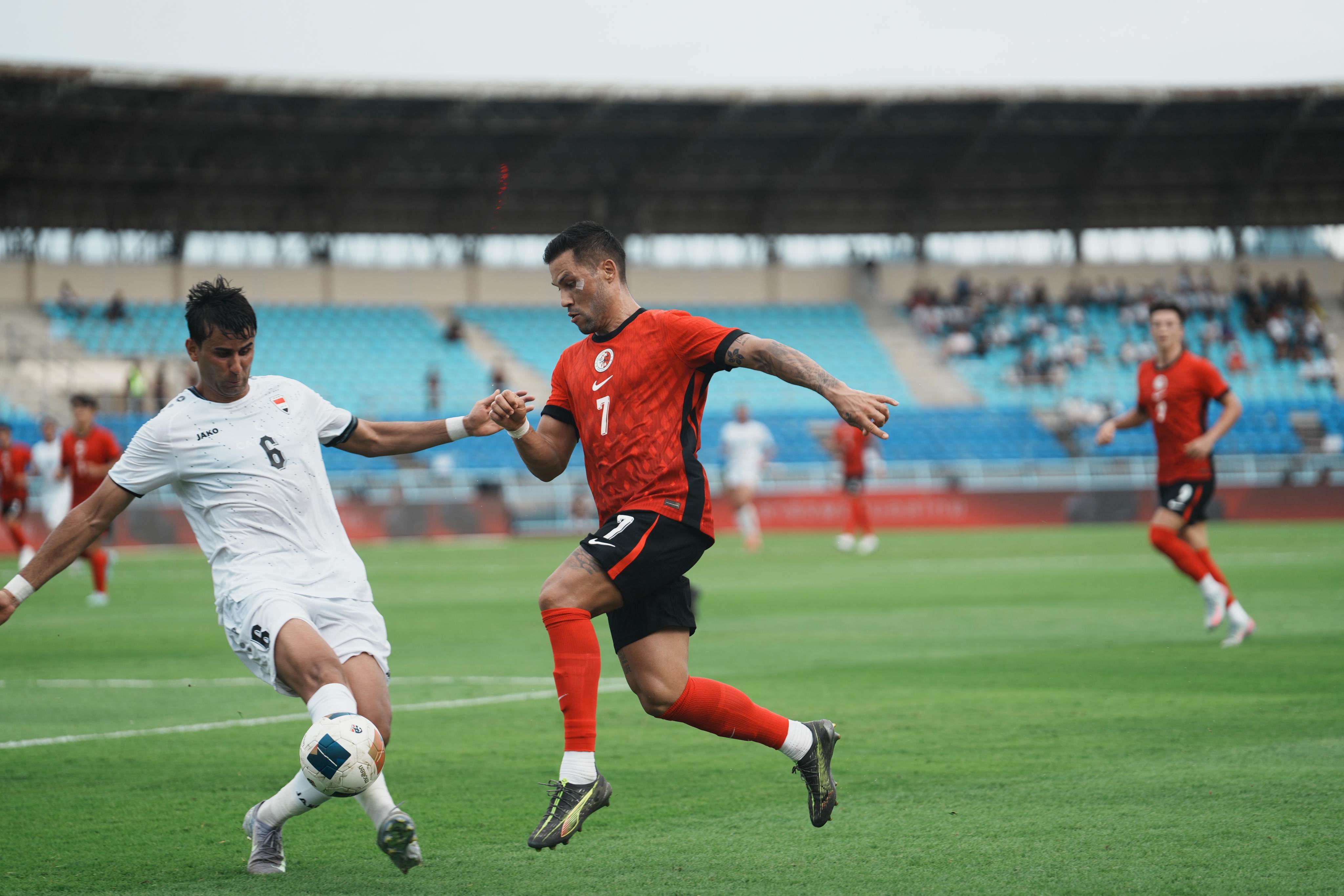 Juninho (right) applies pressure on defender Manaf Younis during Hong Kong’s defeat by Iraq last month. Photo: HKFA