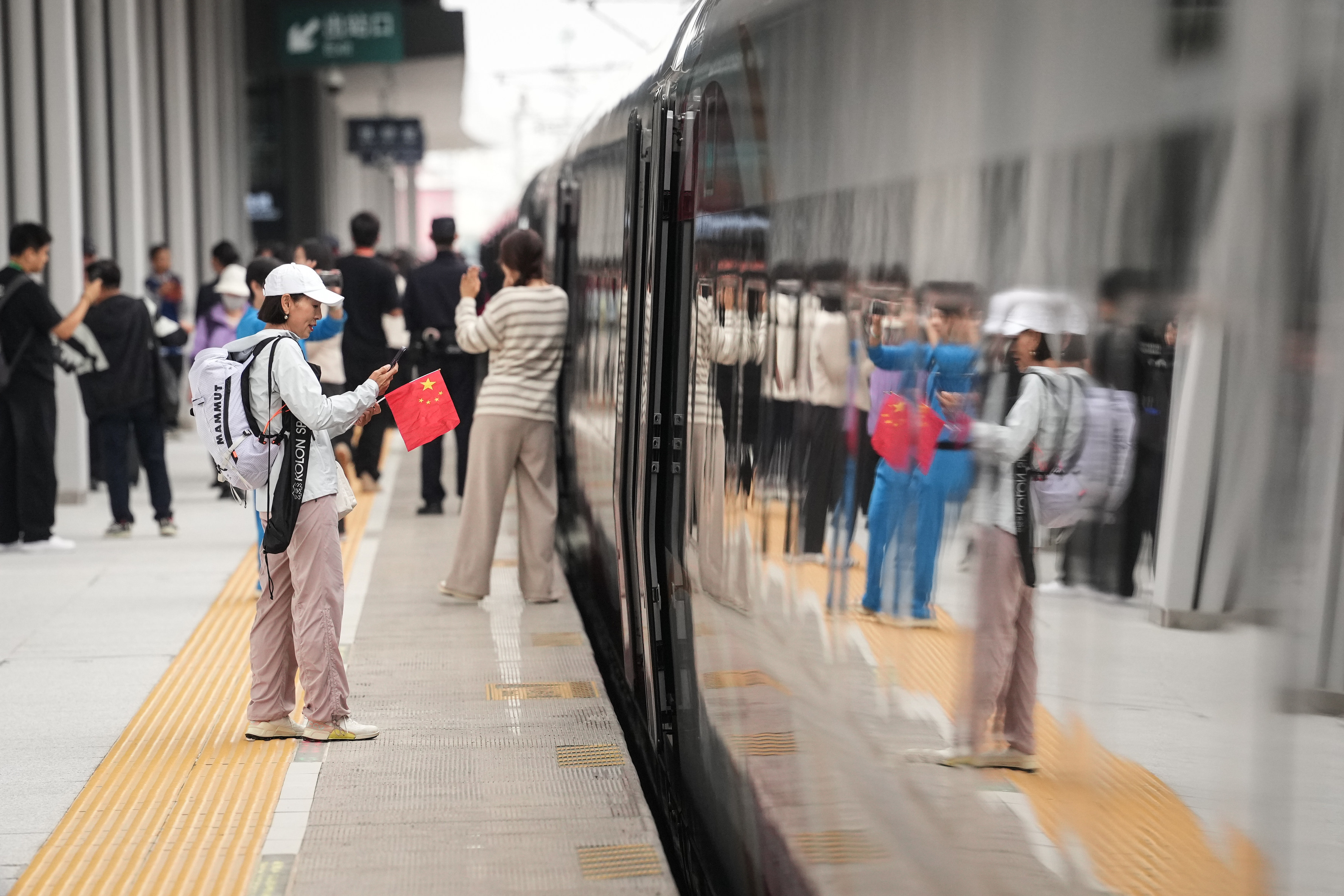 A passenger preparing to board a train in Fushun, Liaoning province on September 28, when the Shenyang-Baihe section of the Shenyang-Jiamusi high-speed railway opened. Photo: Xinhua