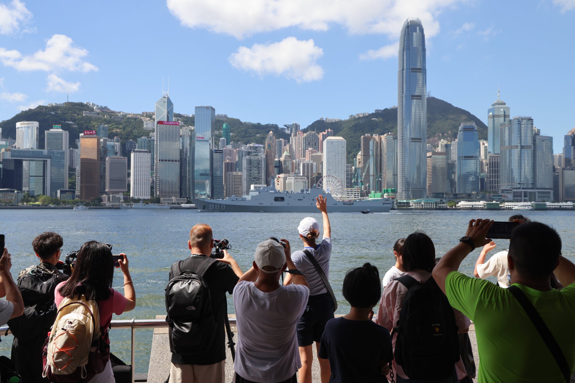People take pictures of amphibious assault ship Yimeng Shan as it departs Hong Kong on Friday morning. Photo: Jelly Tse People take pictures of amphibious assault ship Yimeng Shan as it departs Hong Kong on Friday morning. Photo: Jelly Tse