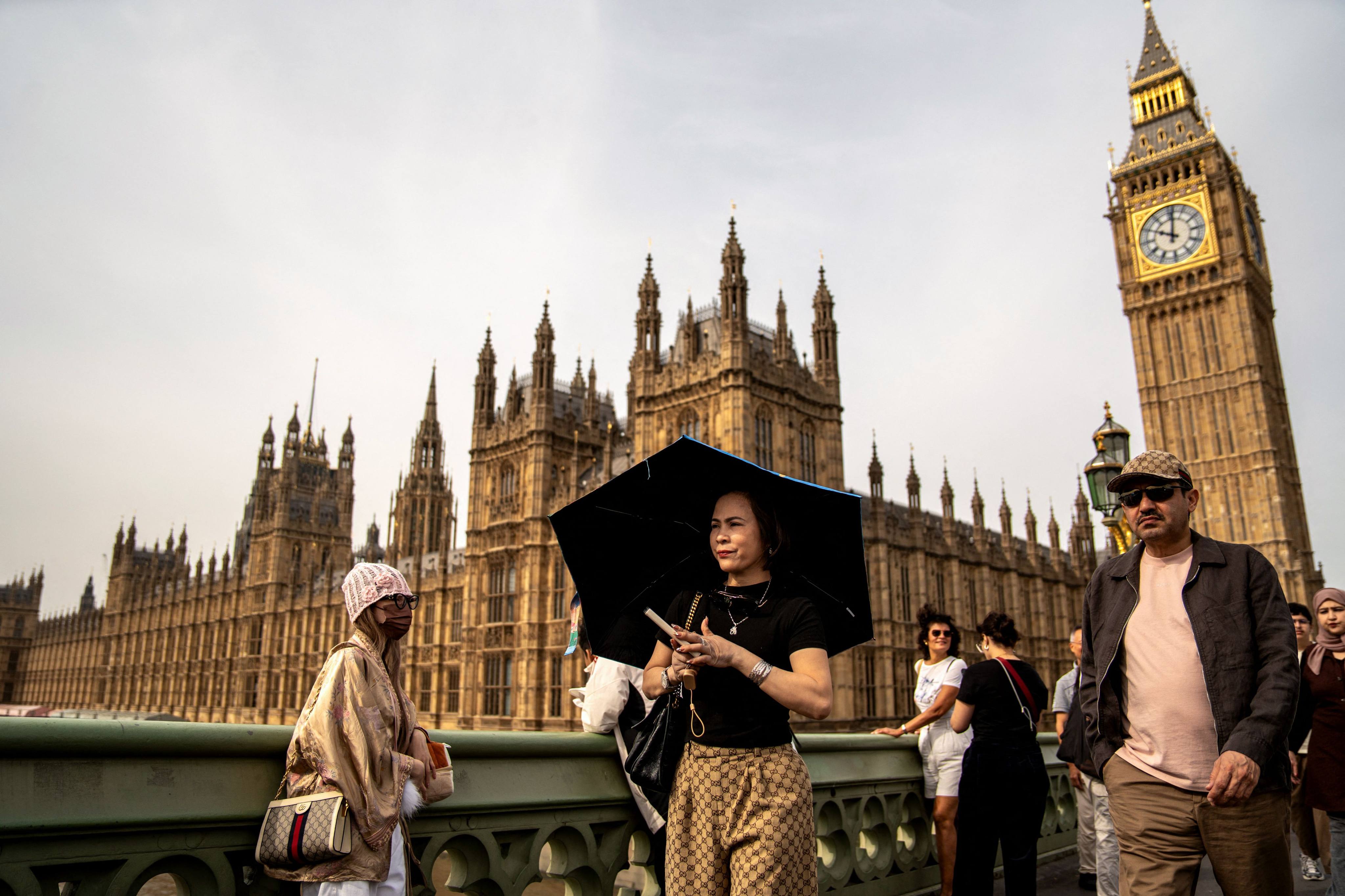 People walk by the Elizabeth Tower, more known as “Big Ben”, one of London’s notable landmarks. File photo: AFP
