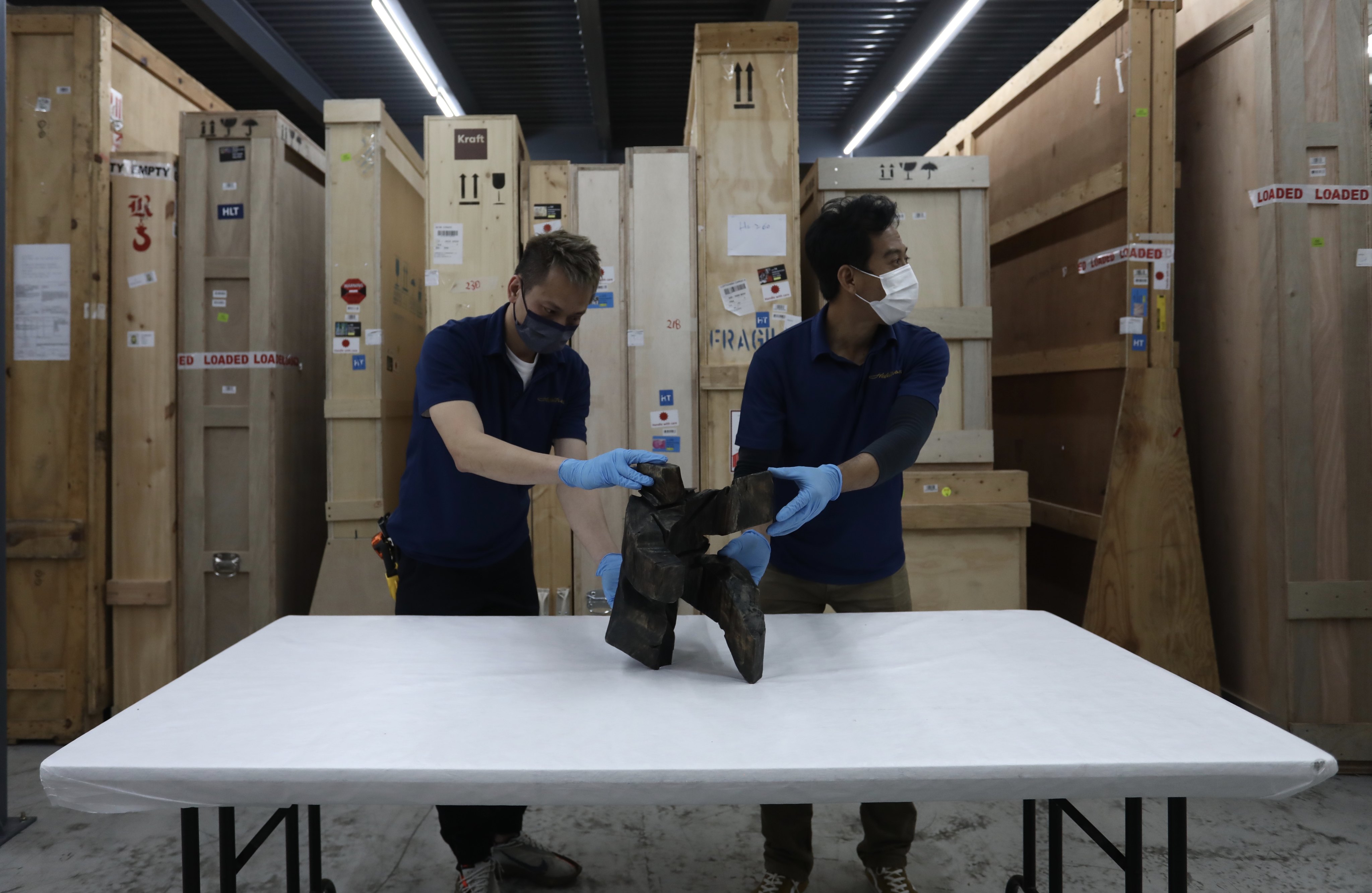 Workers at Christie’s warehouse in Tsing Yi. Photo: Jonathan Wong