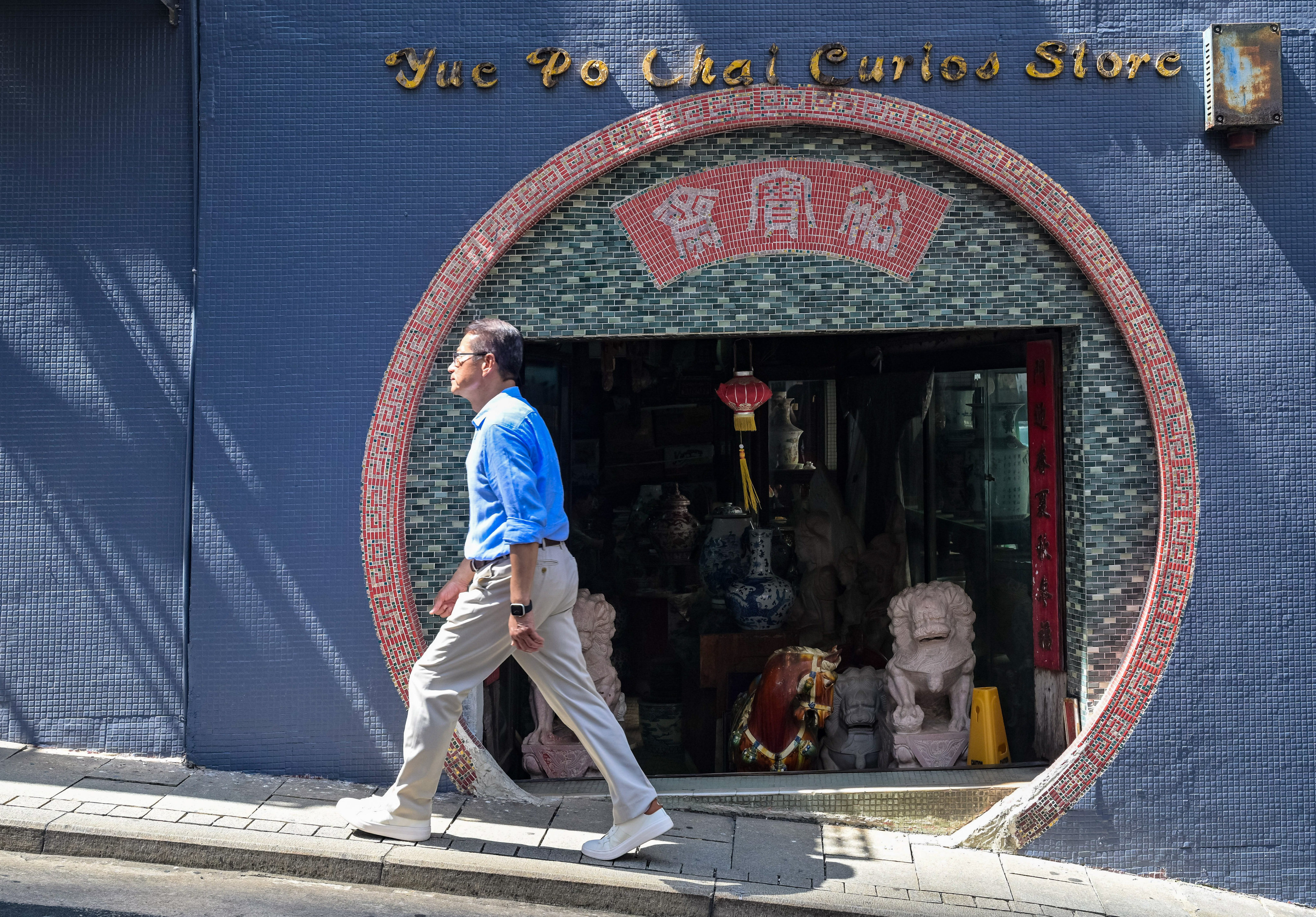 Financial Secretary Paul Chan strolls along Hollywood Road in the Mid-Levels during a recent “city walk.”  Photo: Handout