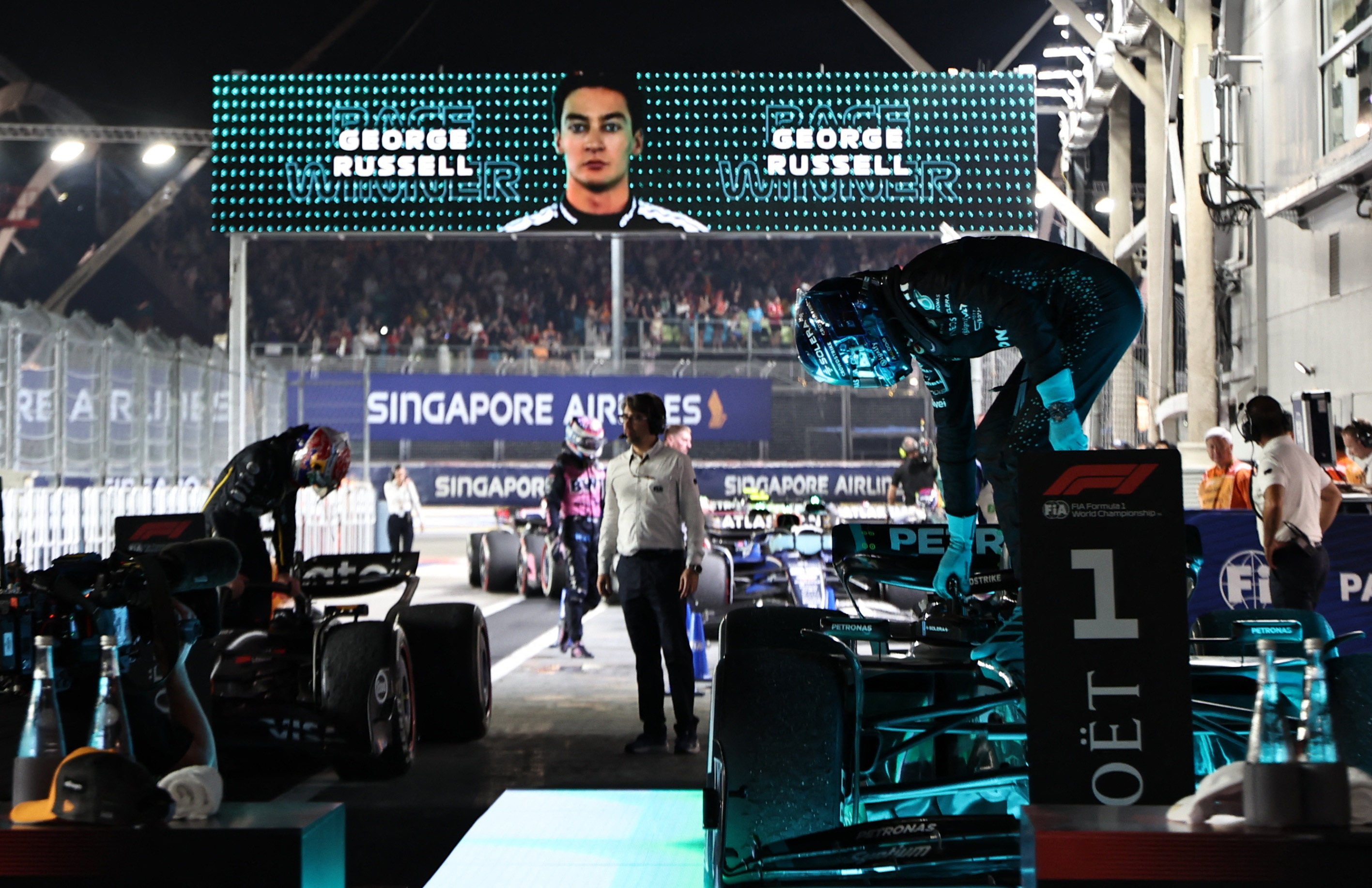 Mercedes’ George Russell climbs out of his car after winning the Singapore Grand Prix. Photo: Reuters