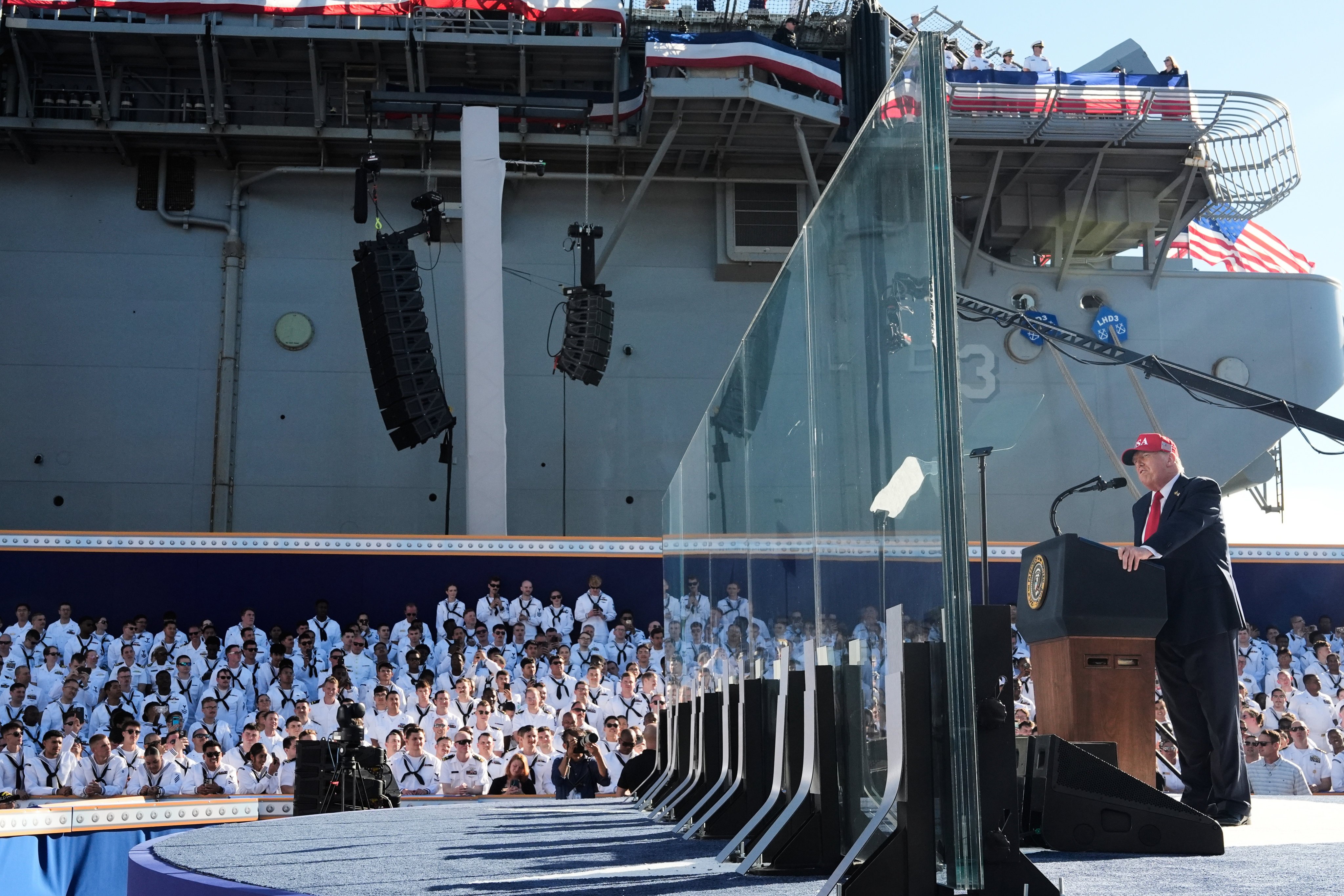 US President Donald Trump speaking behind bulletproof glass aboard the USS Harry S. Truman at Naval Station Norfolk. Photo: AP