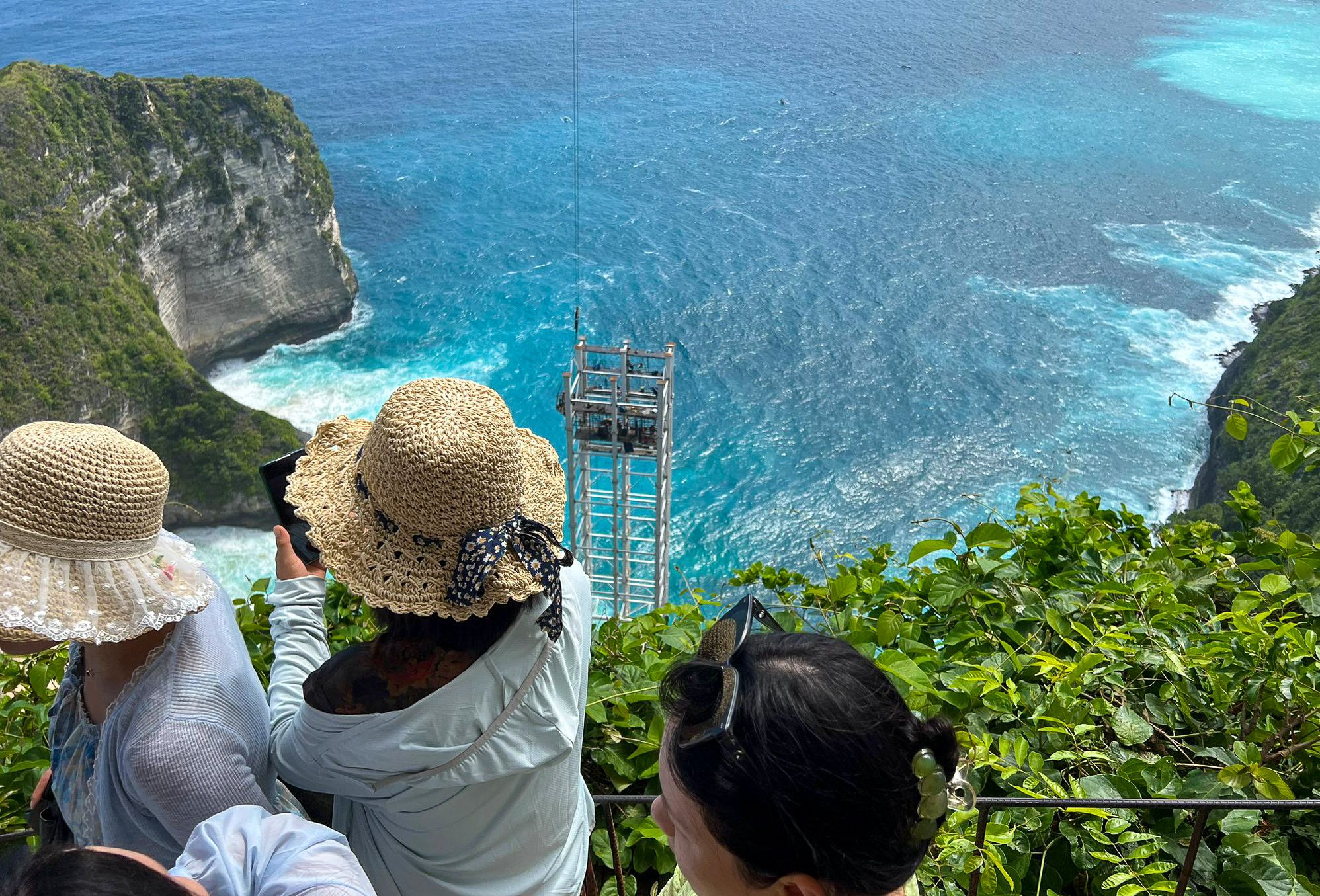 Tourists look at a partly built lift above Kelingking Beach on September 24. Photo: Ralph Jennings
