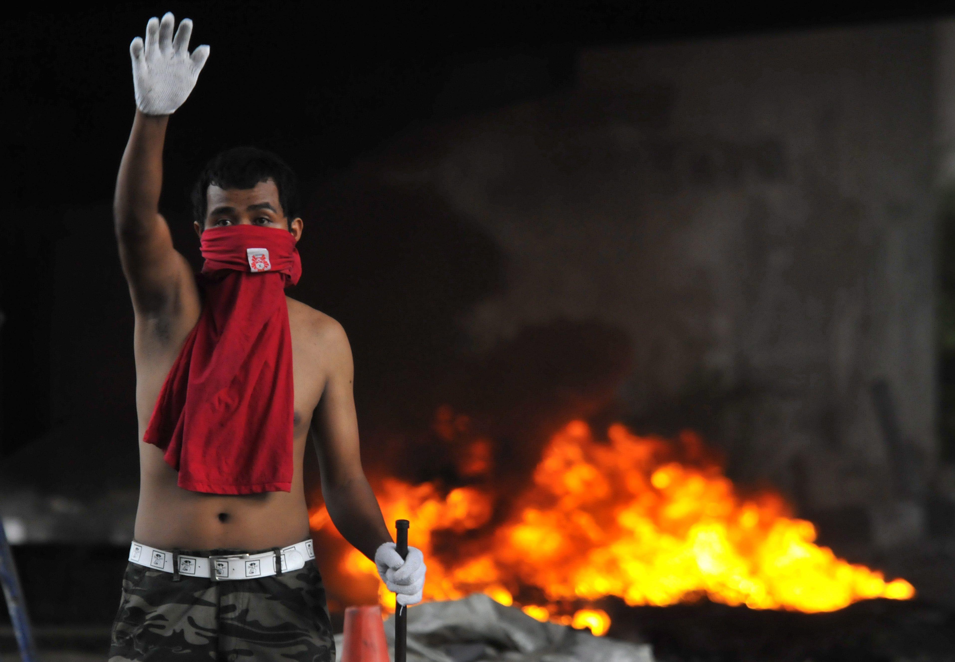 An anti-government protester gestures near Victory Monument in Bangkok, Thailand in May 2010. Photo: EPA