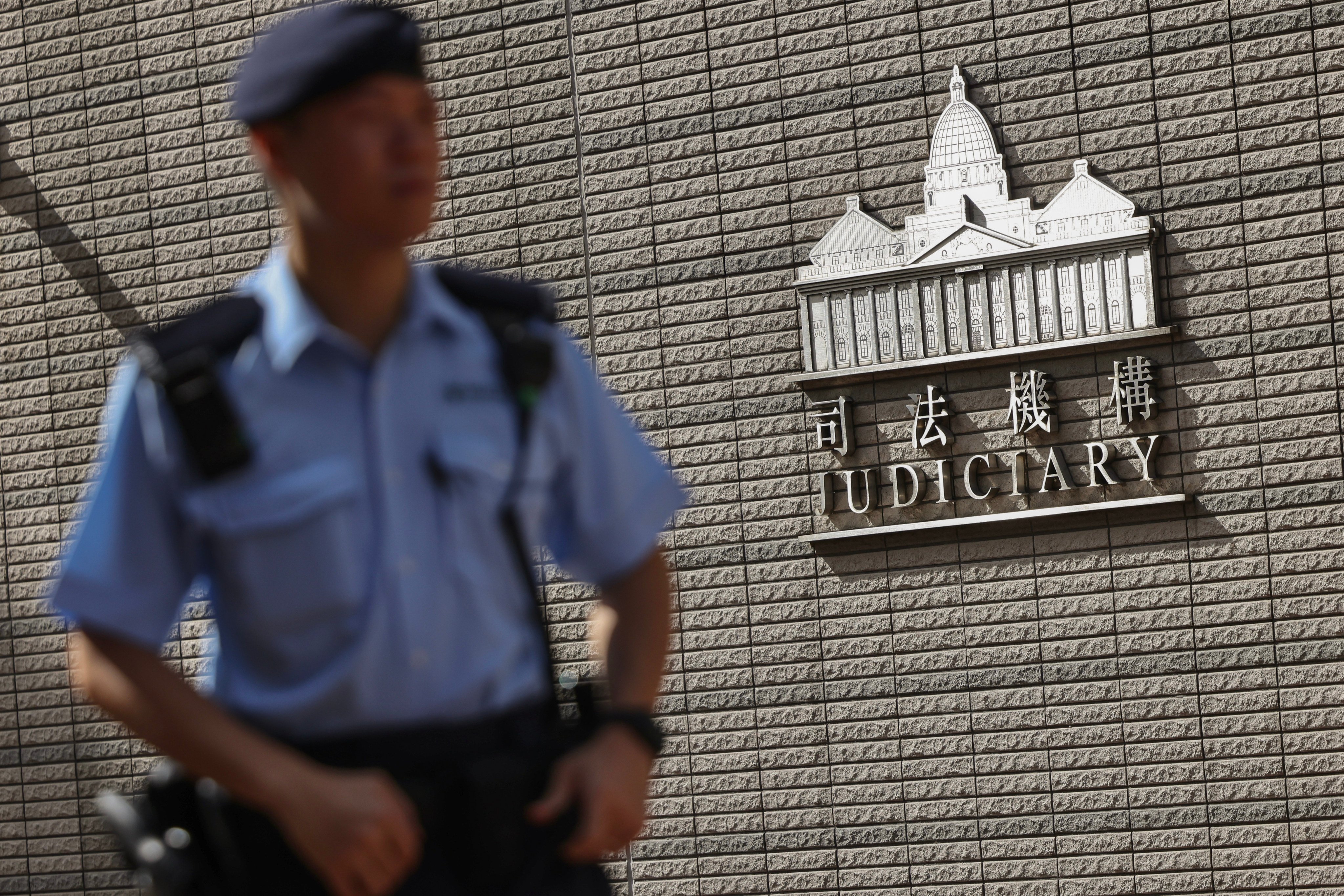 A police officer outside the West Kowloon Magistrates Court on September 29. Photo: Karma Lo