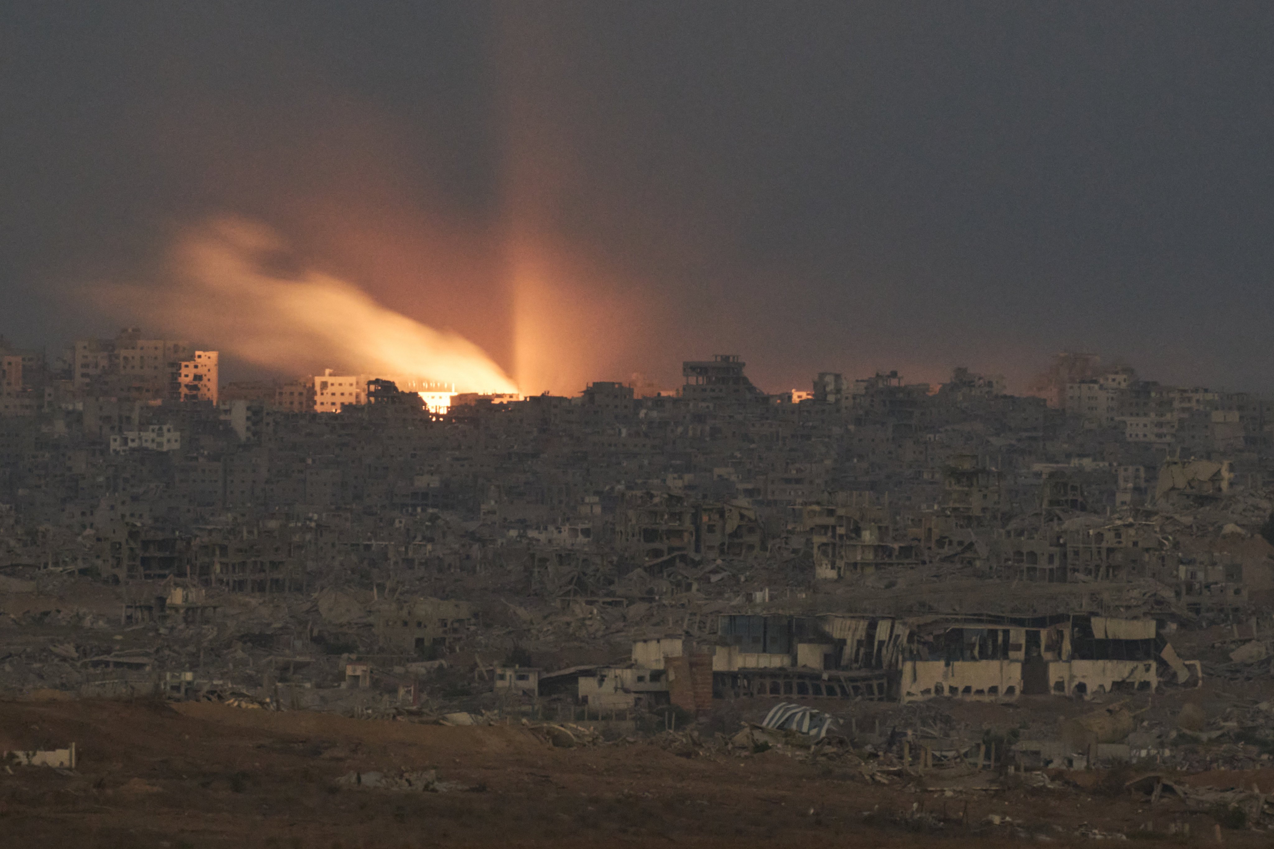 A fire erupts amid destroyed buildings, following an Israeli military strike in the northern Gaza Strip. Photo: AP