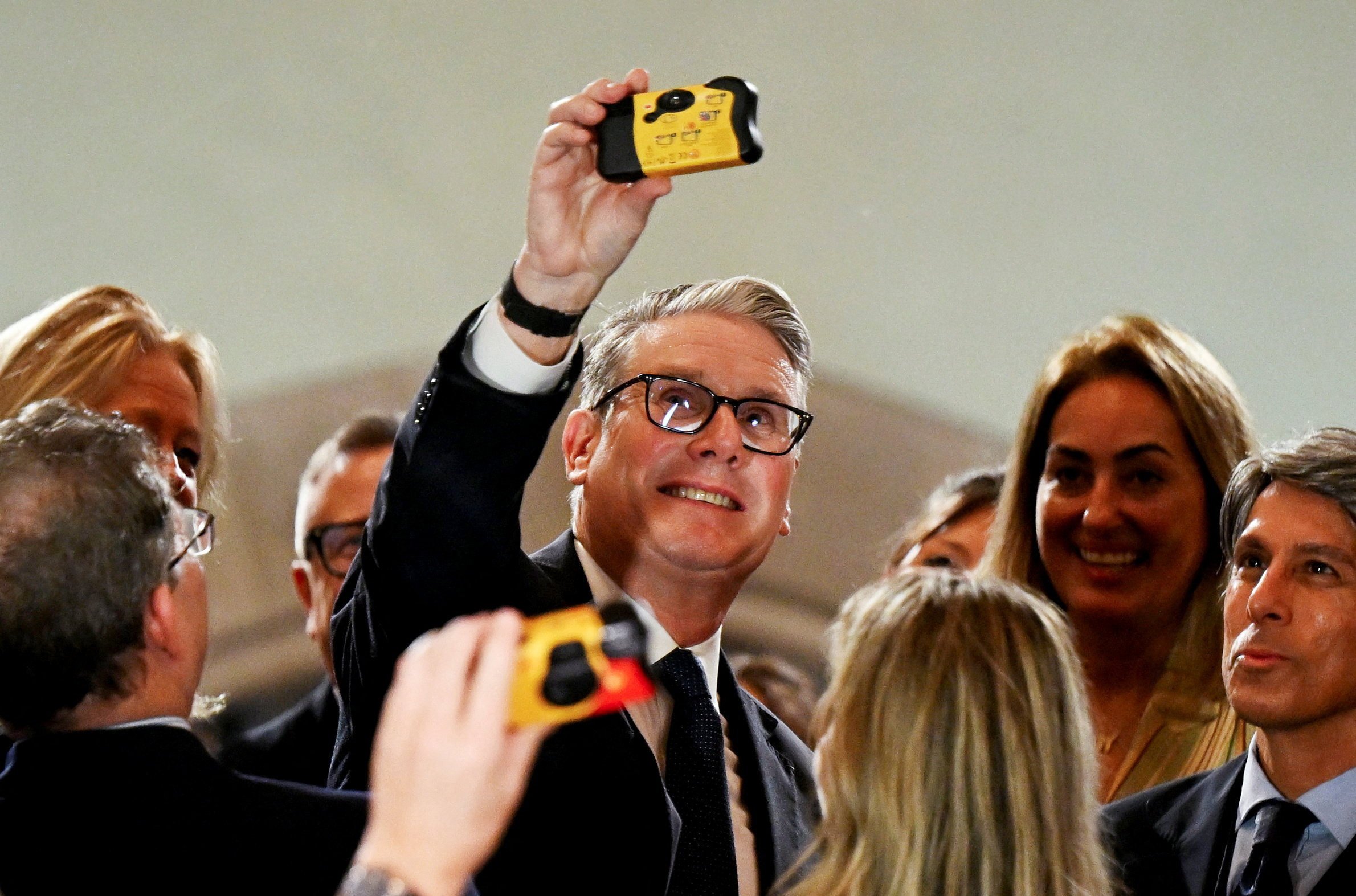 British Prime Minister Keir Starmer takes a selfie with a disposable camera while meeting business leaders at the Taj Mahal Palace in Mumbai on Wednesday. Photo: Reuters