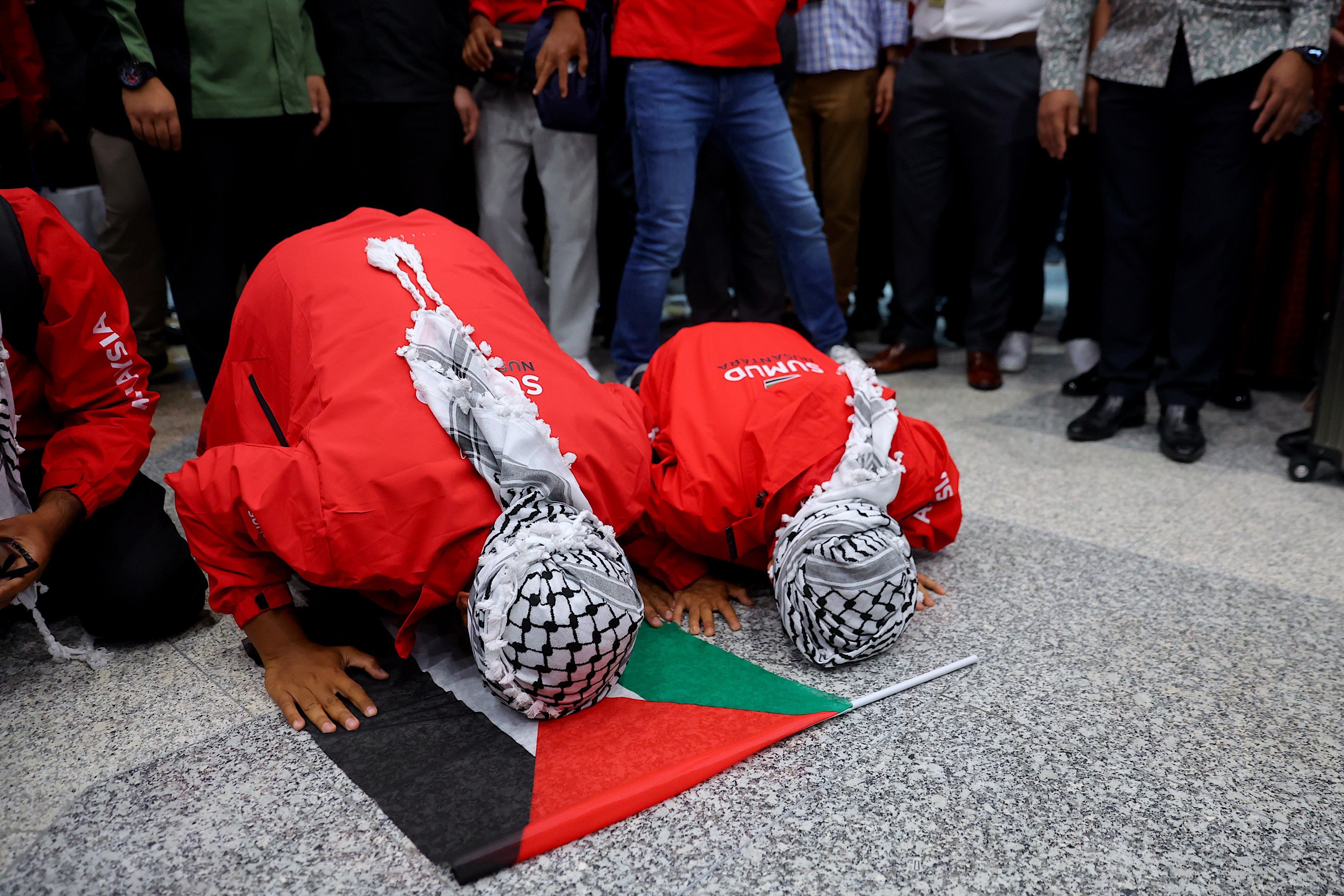 Malaysians from the Global Sumud Flotilla prostrate in prayer upon arriving at Kuala Lumpur International Airport on Tuesday. Photo: EPA