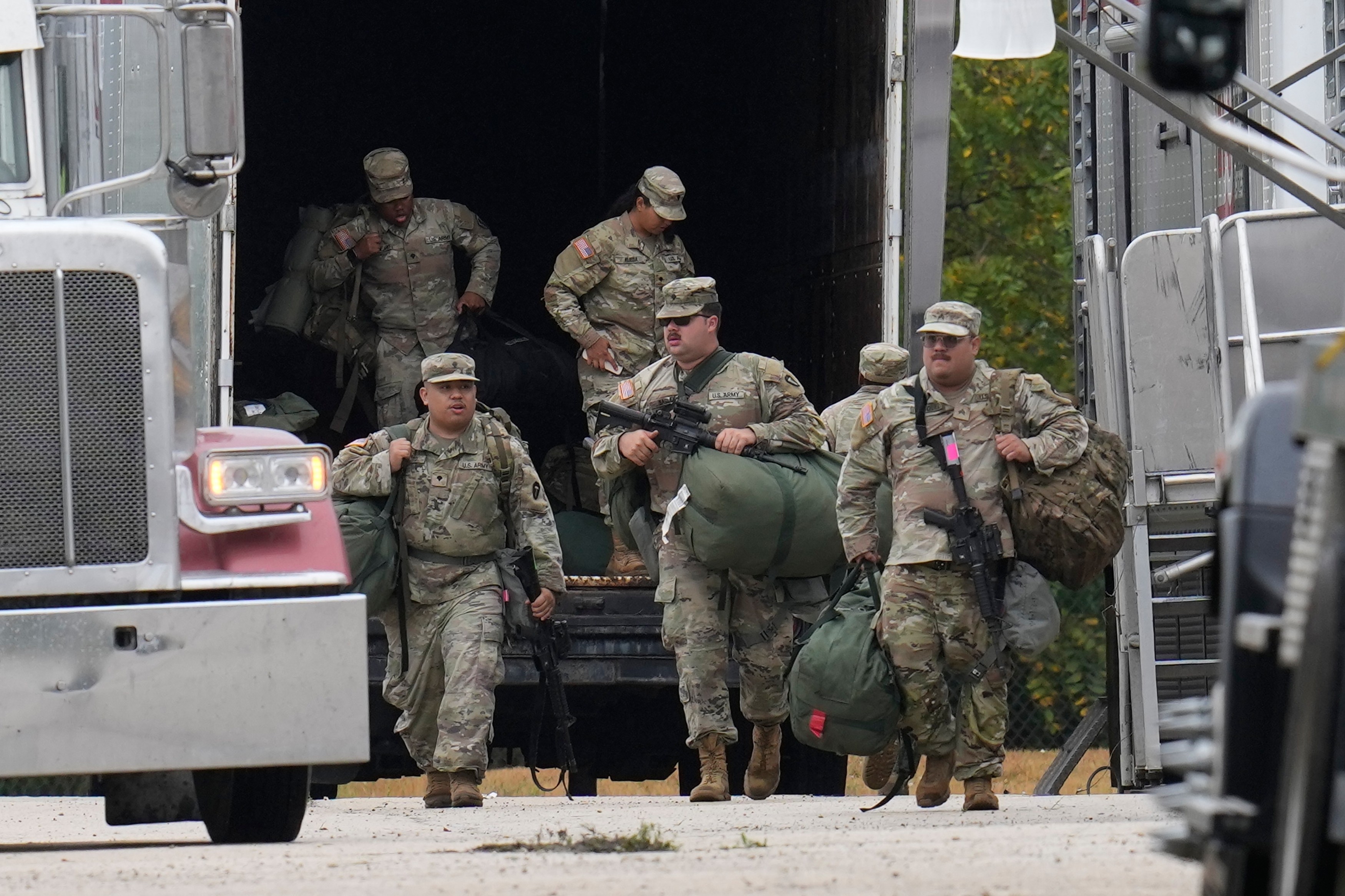 US military personnel in uniform, with the Texas National Guard patch on, are seen in Elwood, Illinois, a Chicago suburb, on Tuesday. Photo: AP