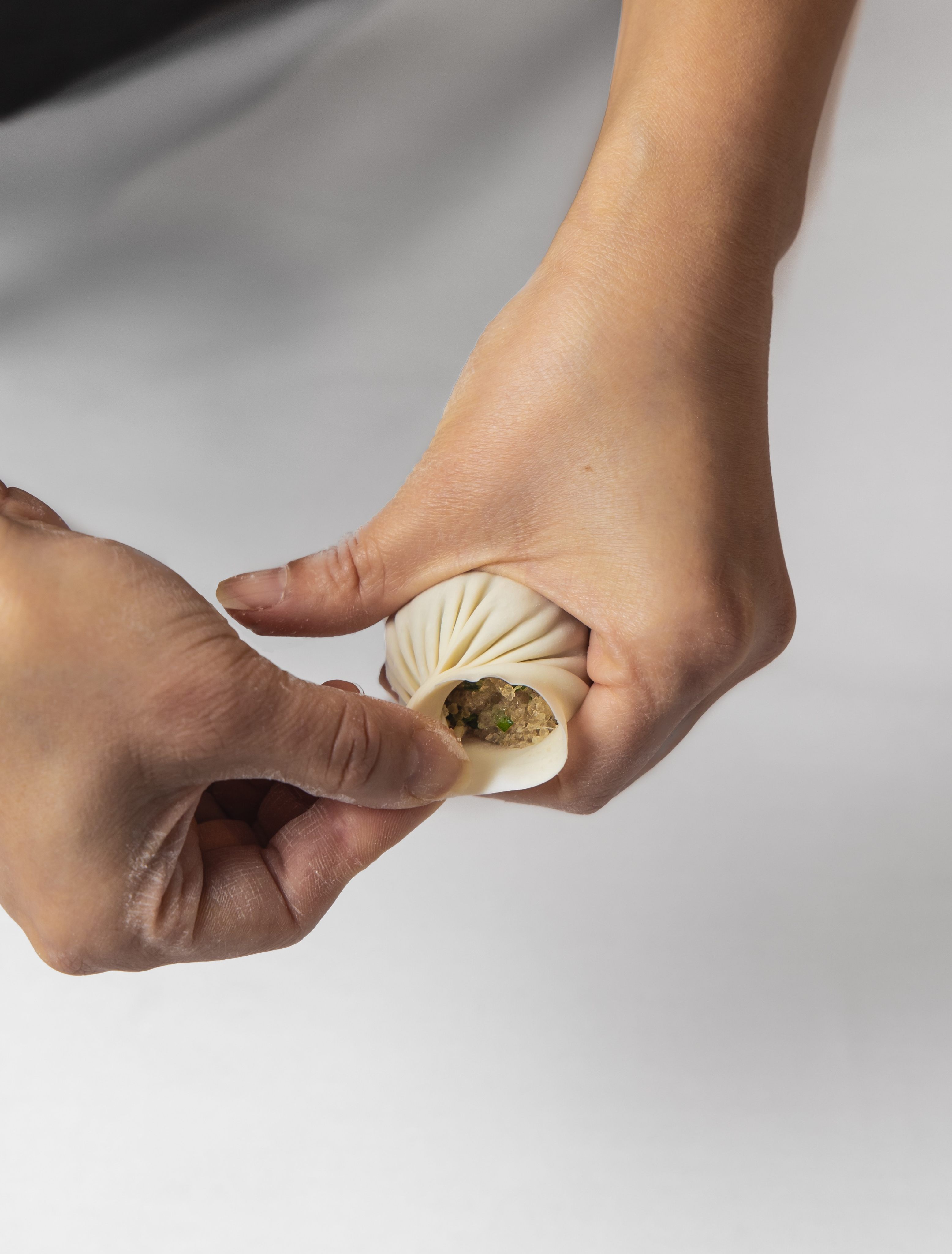 A chef shows the folding technique for xiaolongbao at A.Wong. Photo: James Gillies