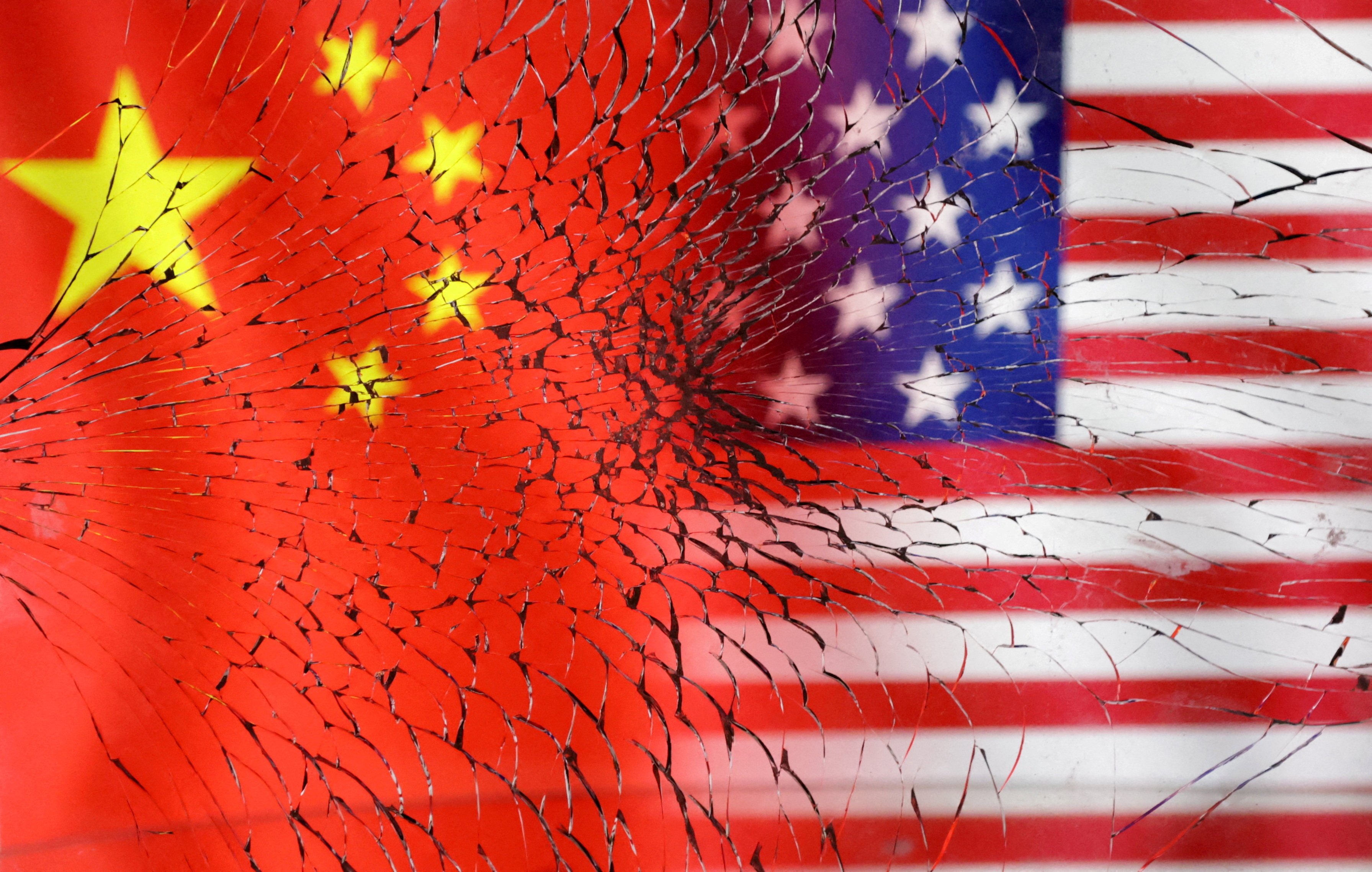 US and Chinese flags are seen through broken glass in this illustration created in January, 2023. Photo: Reuters