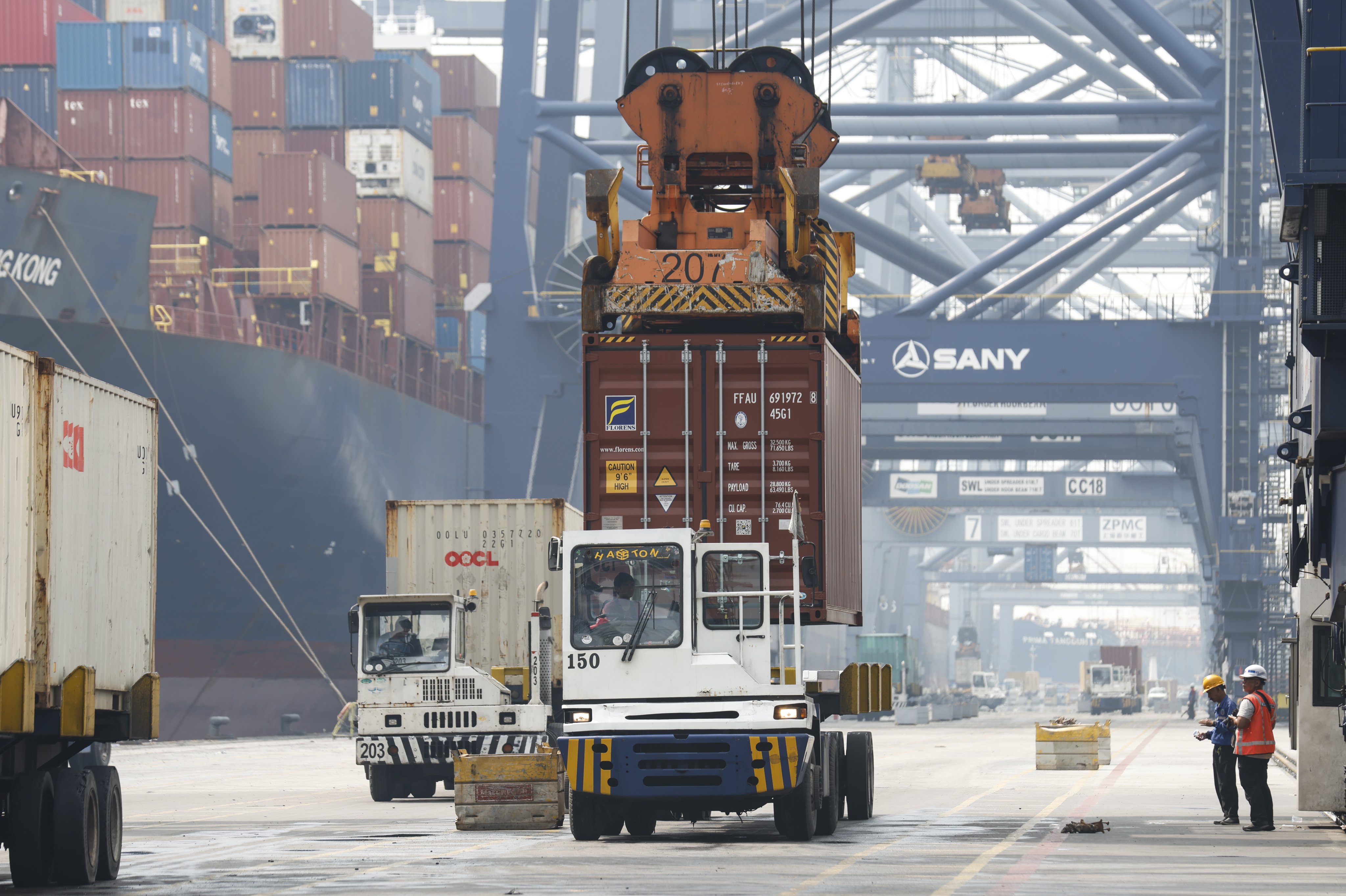 Containers are loaded onto transport trucks at a port in Jakarta, Indonesia in July. Photo: EPA