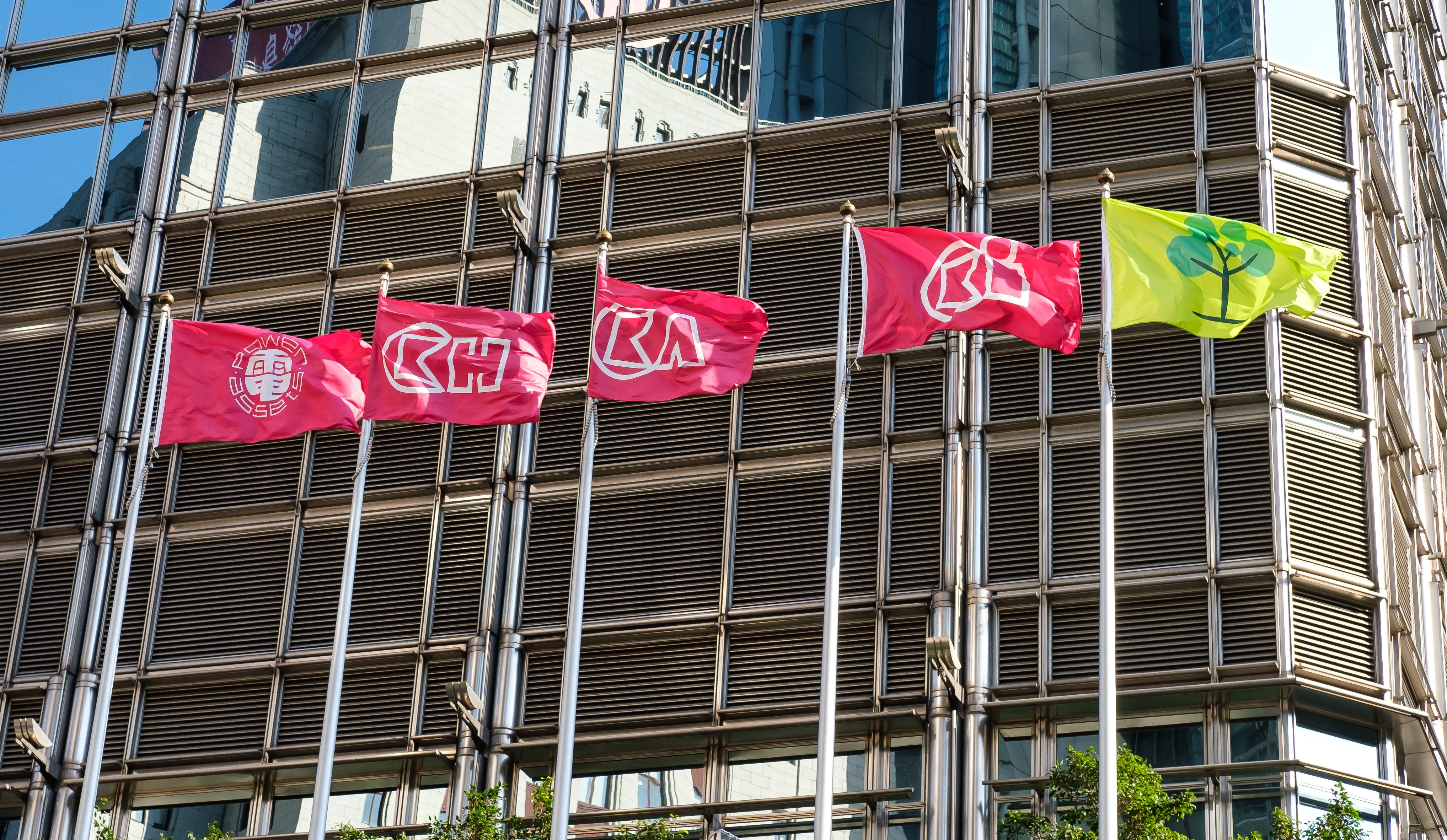 Company flags flutter outside Cheung Kong Centre. CK Life Sciences International is set to merge its subsidiary Polynoma with TransCode Therapeutics to boost its pipeline of anticancer drugs. Photo: Shutterstock