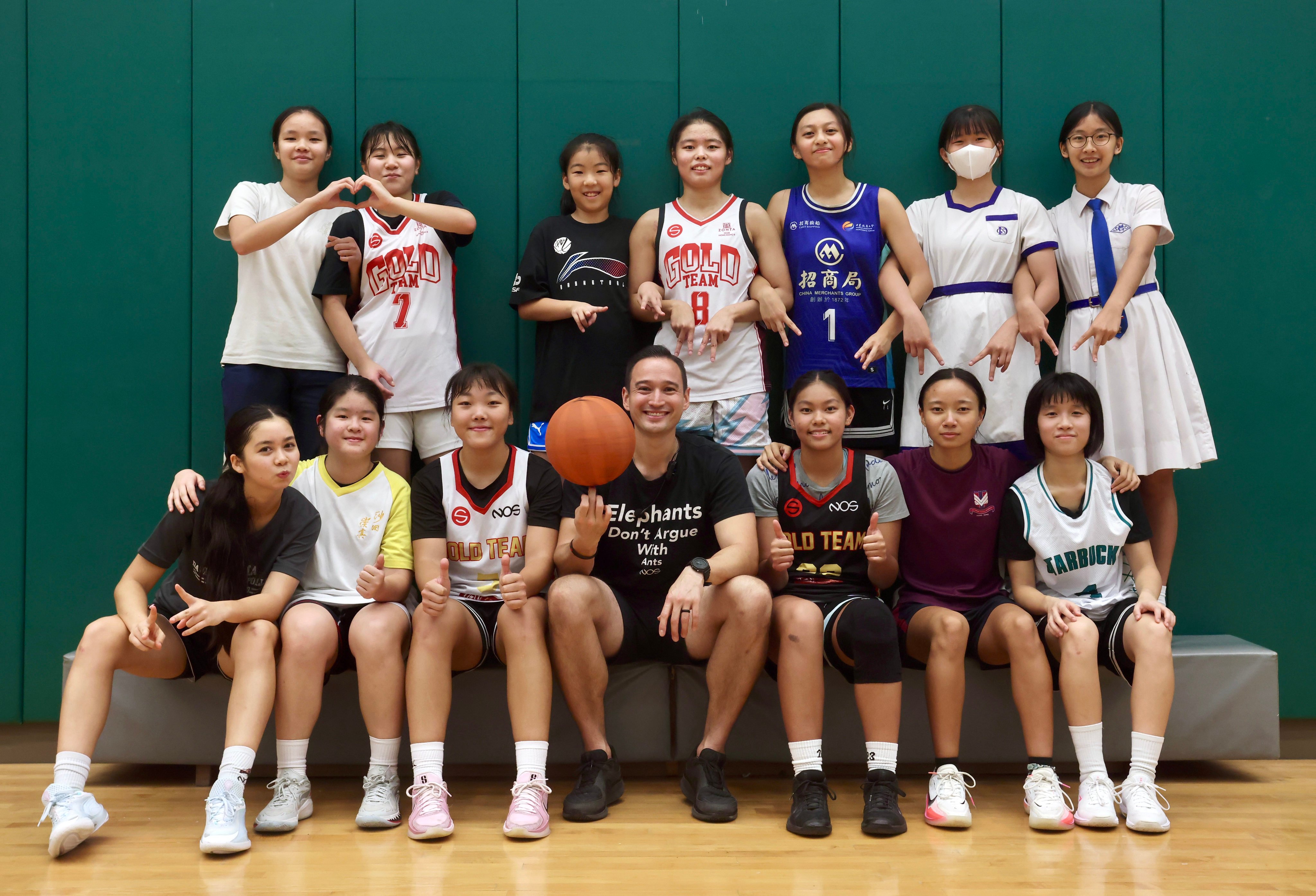 The Strive Gold Team with coach William Lo (front row, centre) pose for a photo at Boundary Street Sports Centre in Kowloon, Hong Kong. The team is the focus of a new documentary by Joanna Bowers. Photo: Jonathan Wong