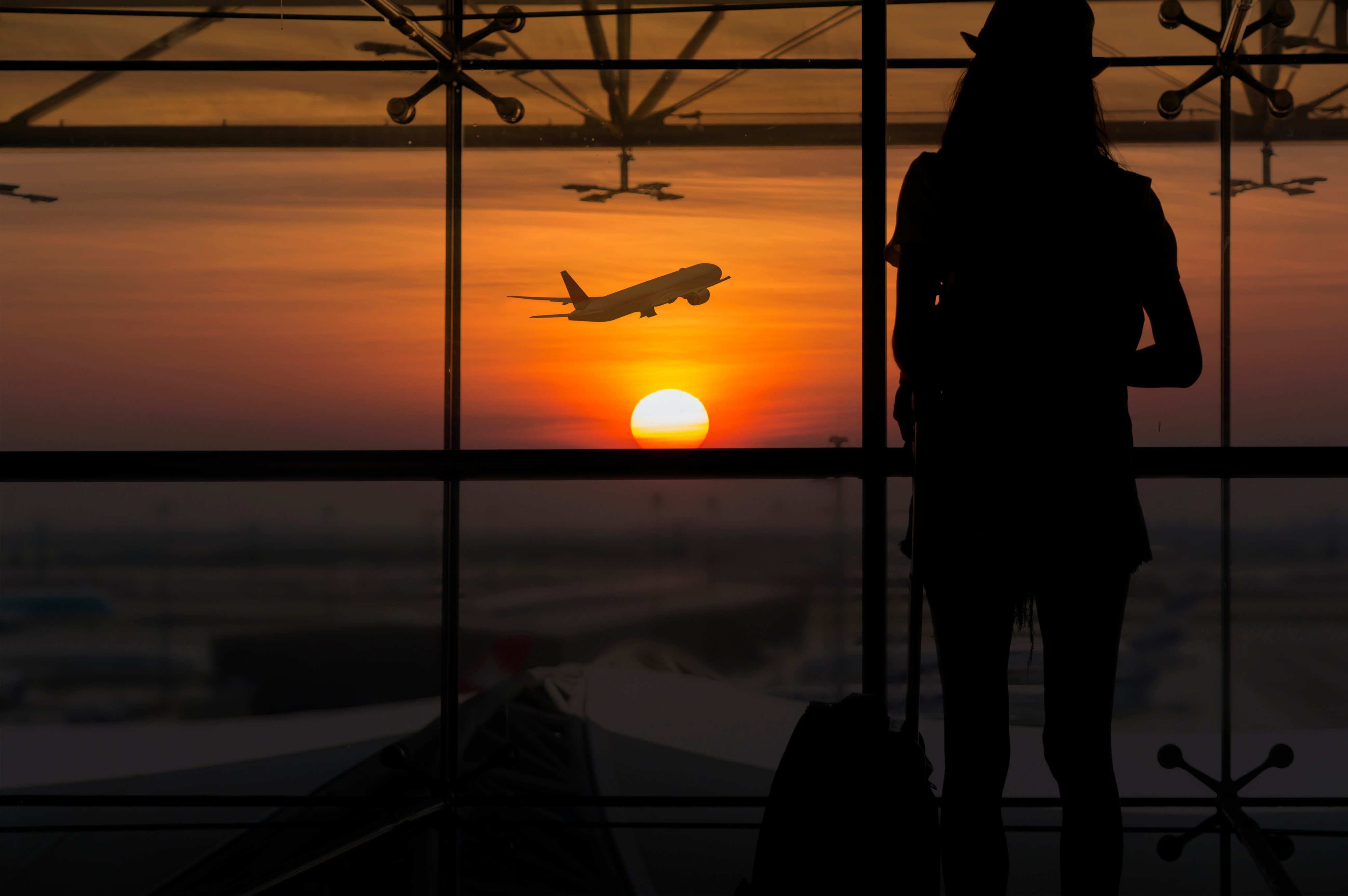 A woman watches plane take off at the airport. Photo: Shutterstock