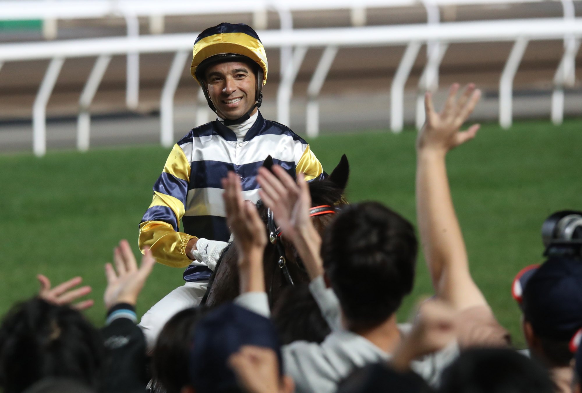 Joao Moreira celebrates with the Sha Tin crowd. Joao Moreira celebrates with the Sha Tin crowd.