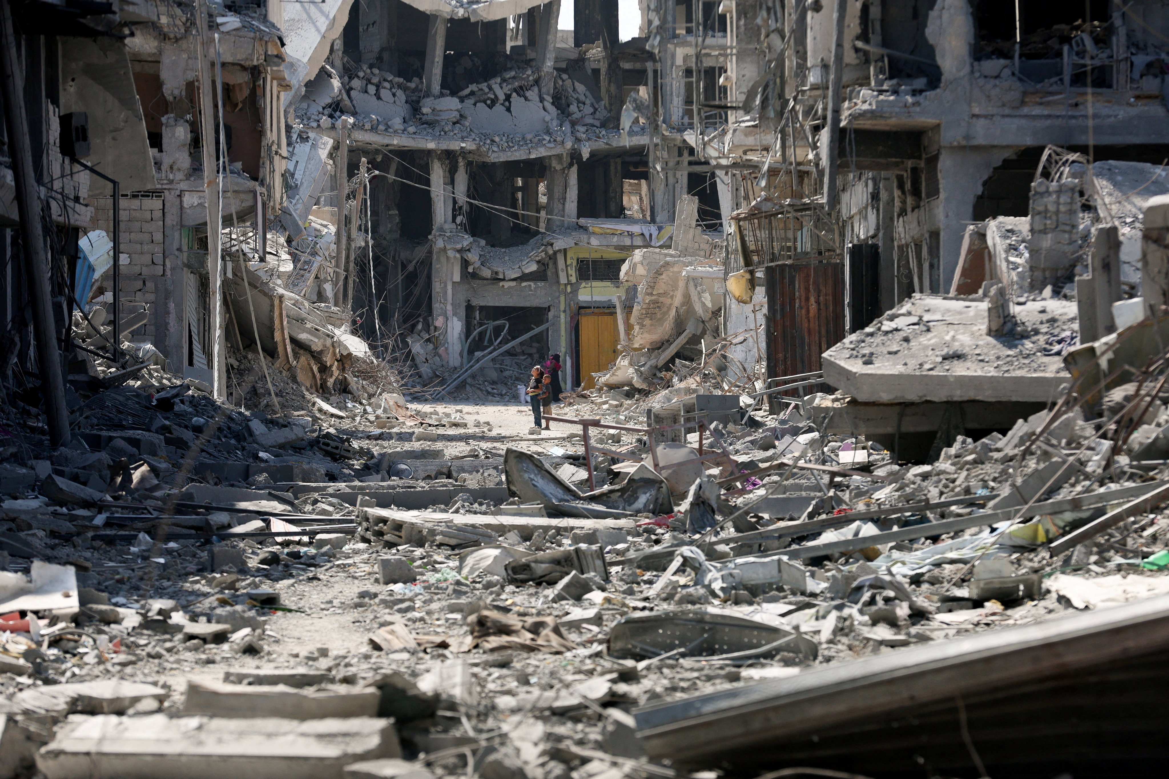 Palestinian children look at rubble following Israeli forces’ withdrawal from the area, after Israel and Hamas agreed on the Gaza ceasefire, in Khan Younis in the southern Gaza Strip on Friday. Photo: Reuters