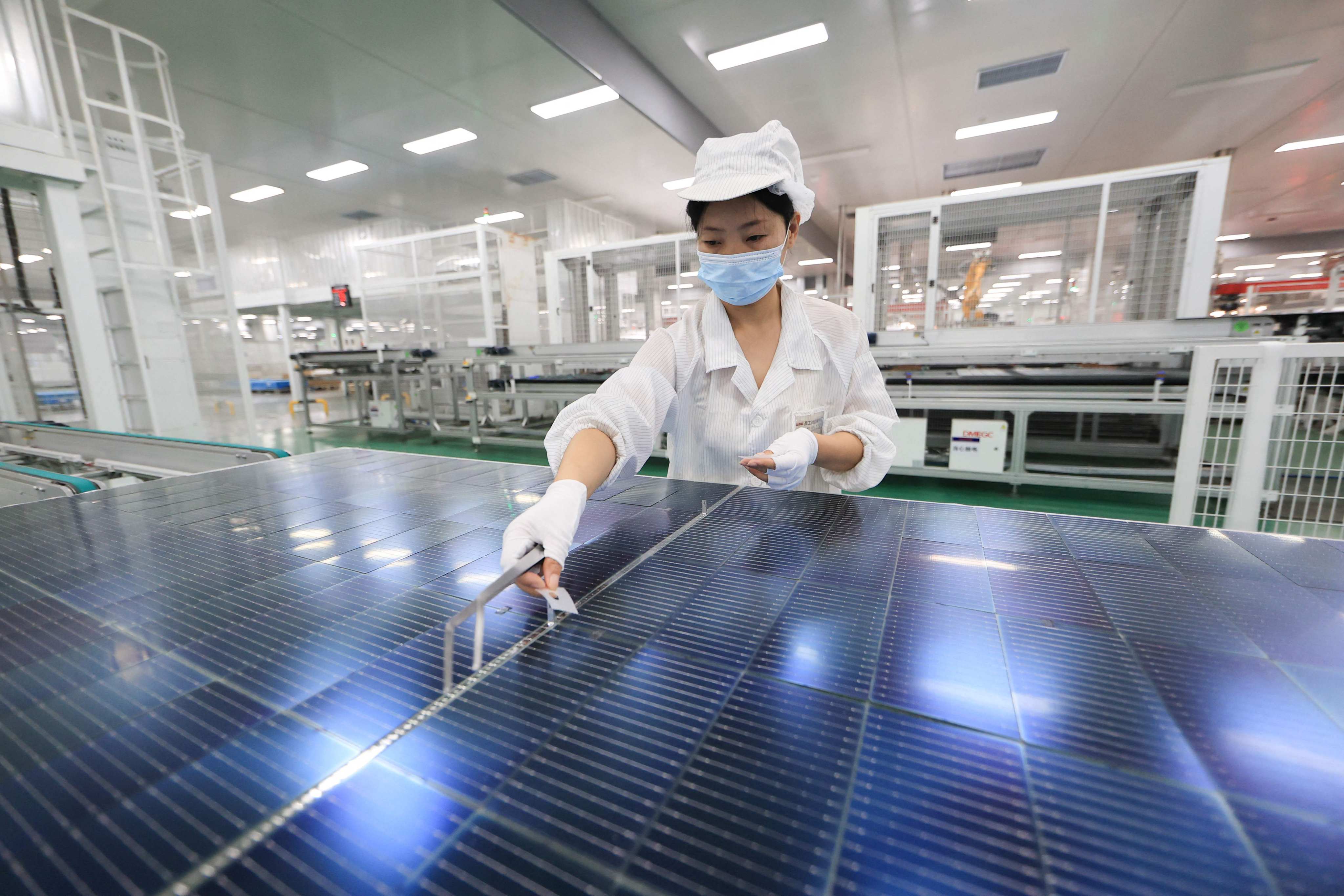 An employee works on photovoltaic cell modules at an export-focused factory n Lianyungang, Jiangsu province, last month. Photo: AFP