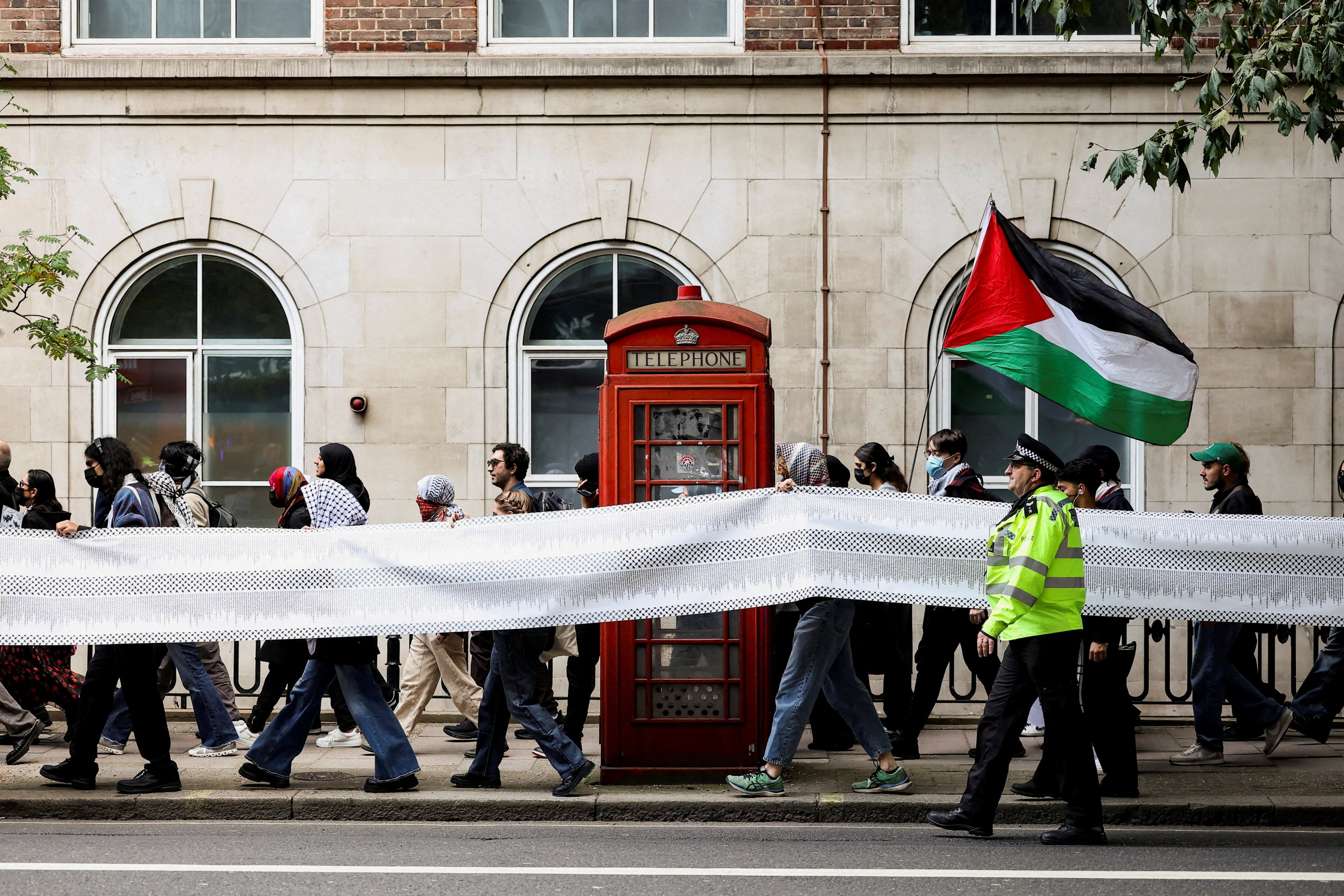 Students hold a banner listing some of the tens of thousands of civilians said to have been killed in Gaza over the past two years, during an inter-university march in support of Palestinians in London on October 7, the second anniversary of the deadly attack on Israel by Hamas. Photo: Reuters
