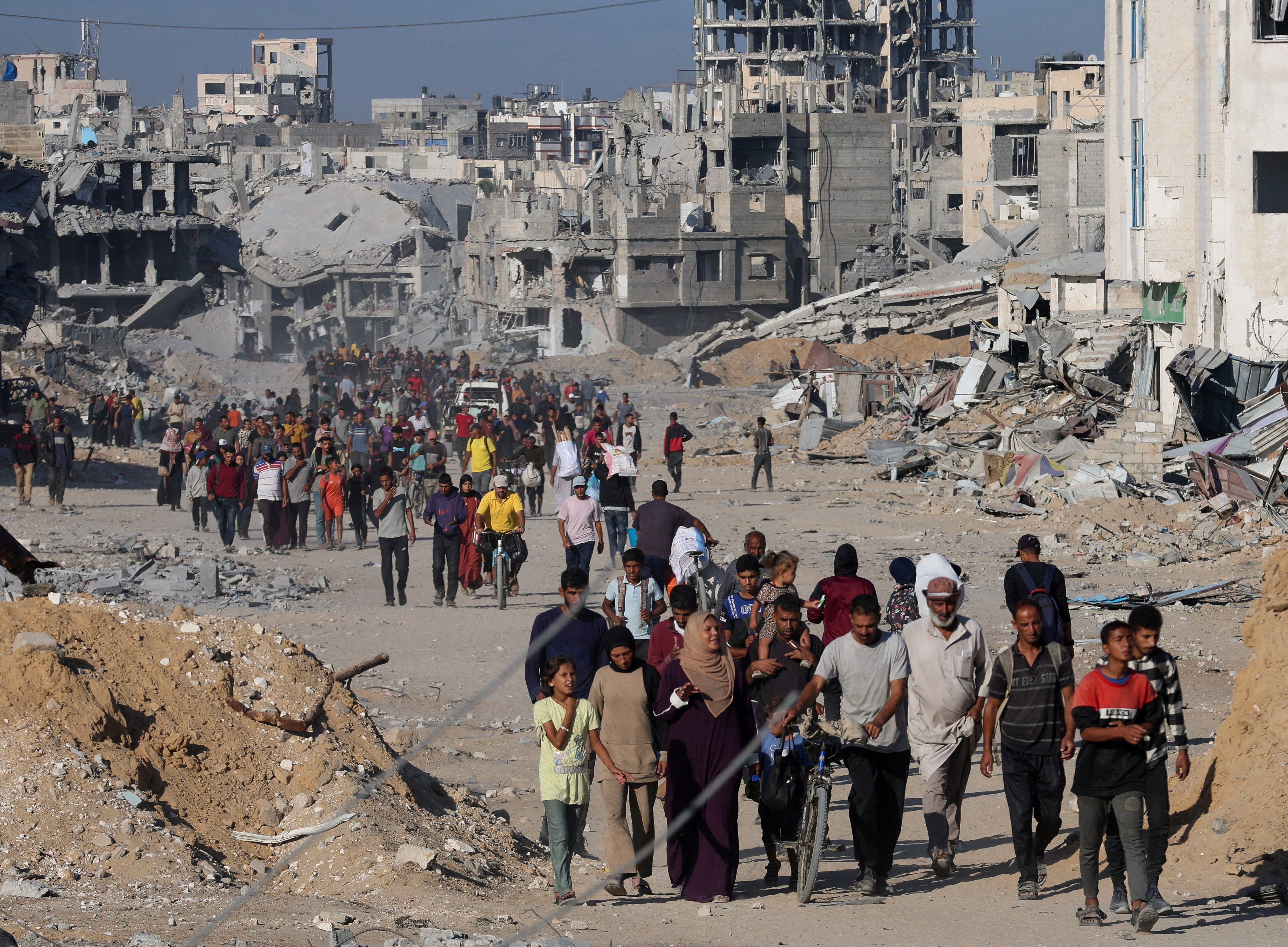Palestinians walk past rubble as they return to their neighbourhood in Khan Younis, in southern Gaza Strip on Saturday, following Israeli forces’ withdrawal from the area, amid a ceasefire between Israel and Hamas in Gaza. Photo: Reuters