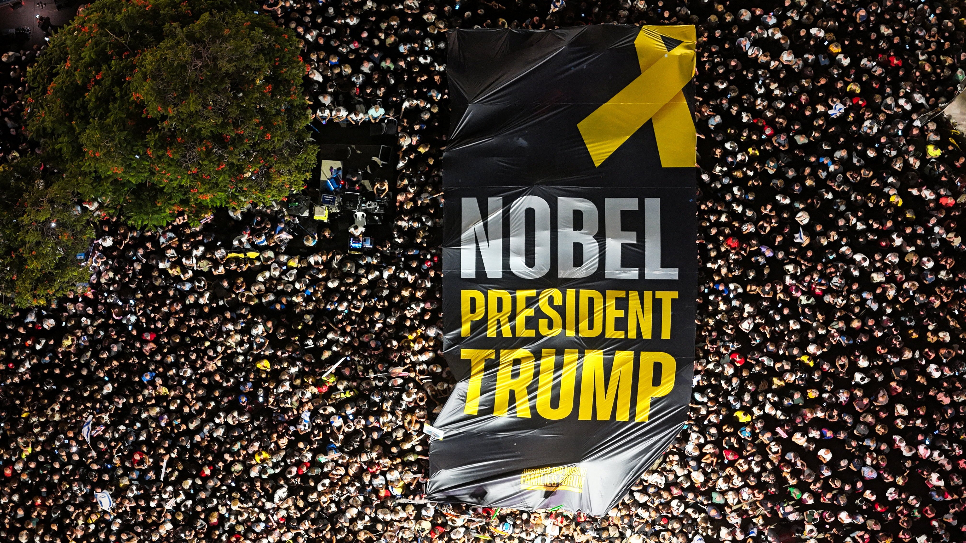 People hold up a giant sign with the words “NOBEL PRESIDENT TRUMP” as they gather in Tel Aviv, Israel, on Saturday. Photo: Reuters