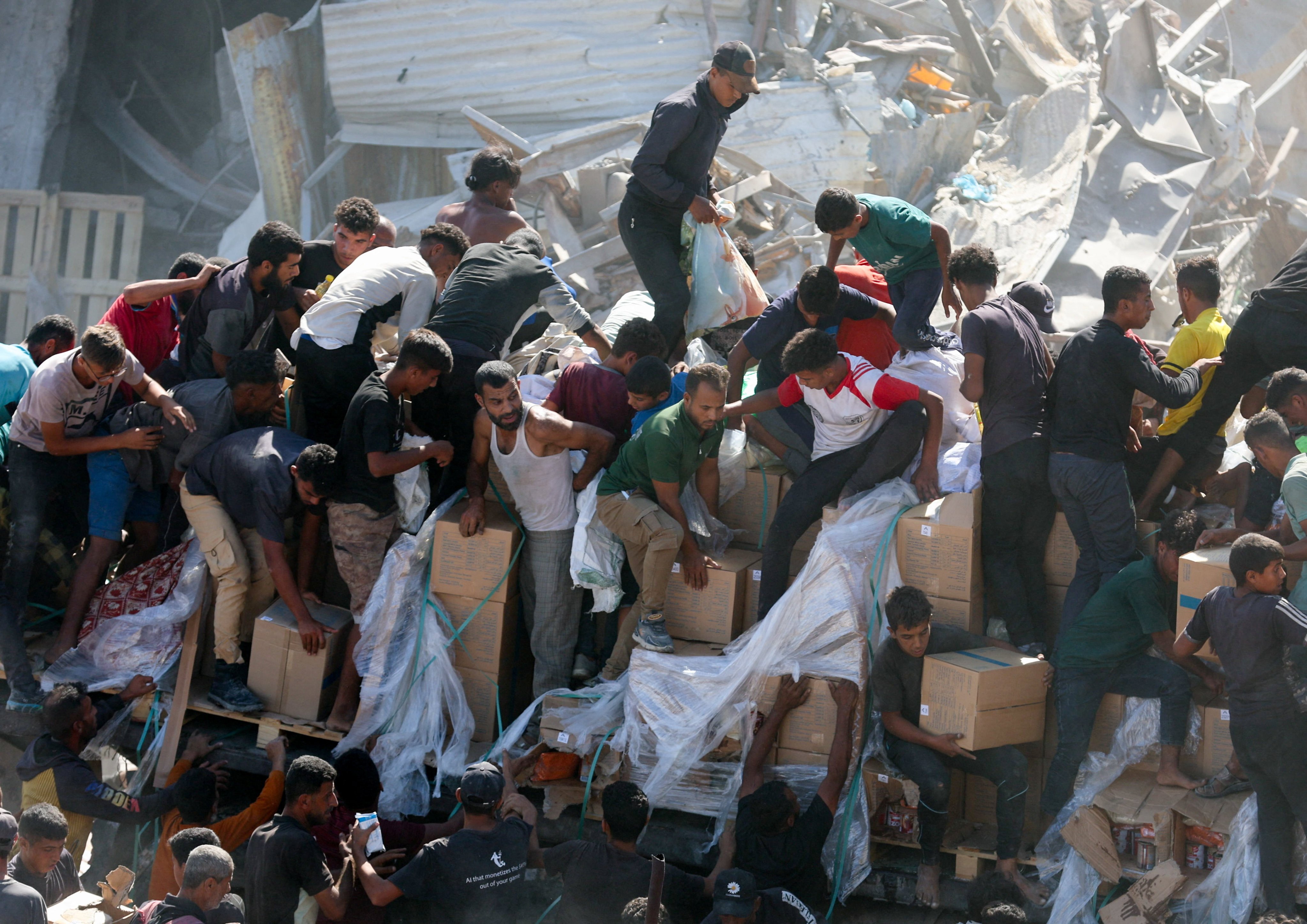 Palestinians collect aid supplies from a truck that entered Gaza on Sunday. Photo: Reuters