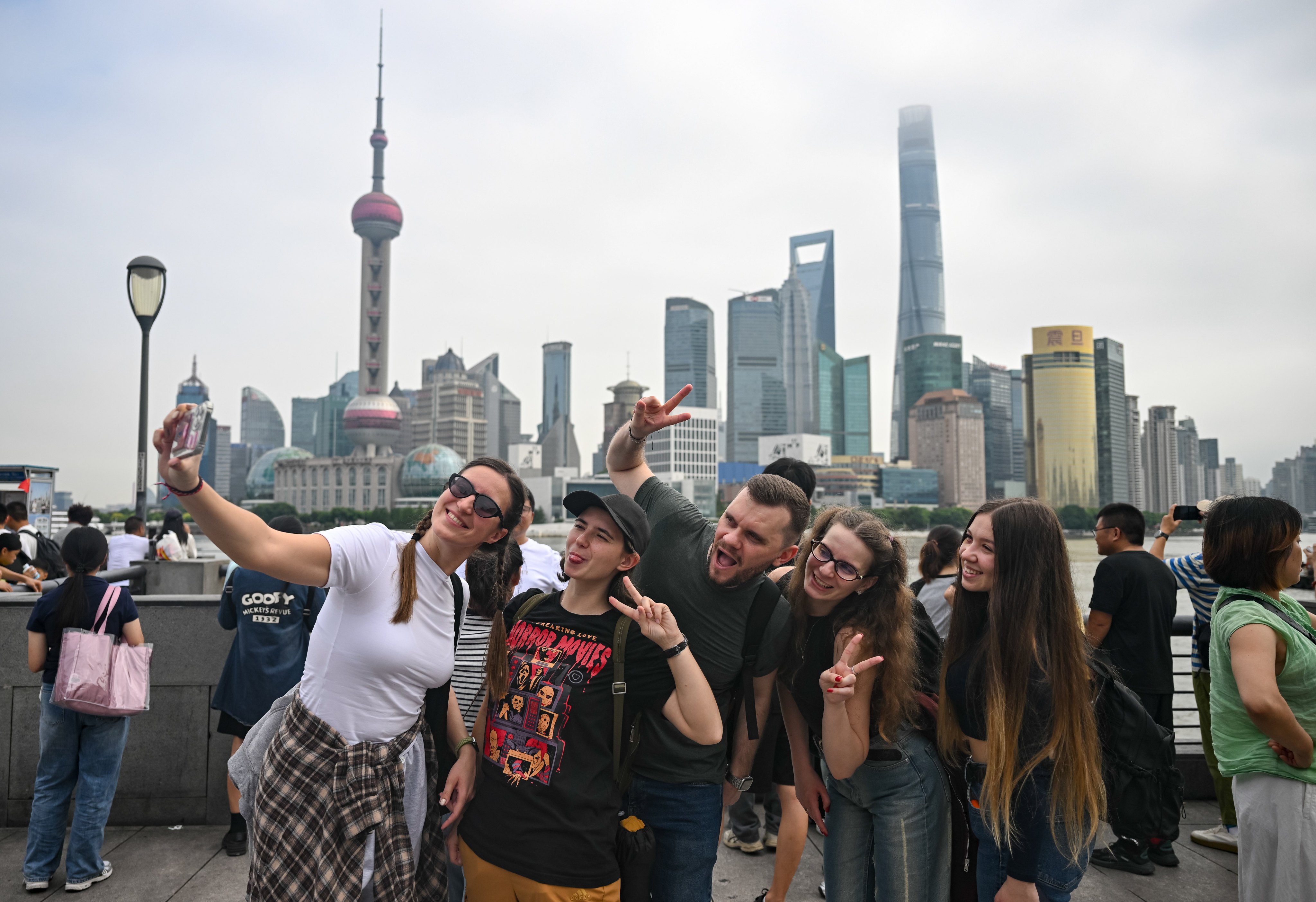 Tourists take selfies on the Bund in Shanghai on October 4, 2025. Photo: Xinhua