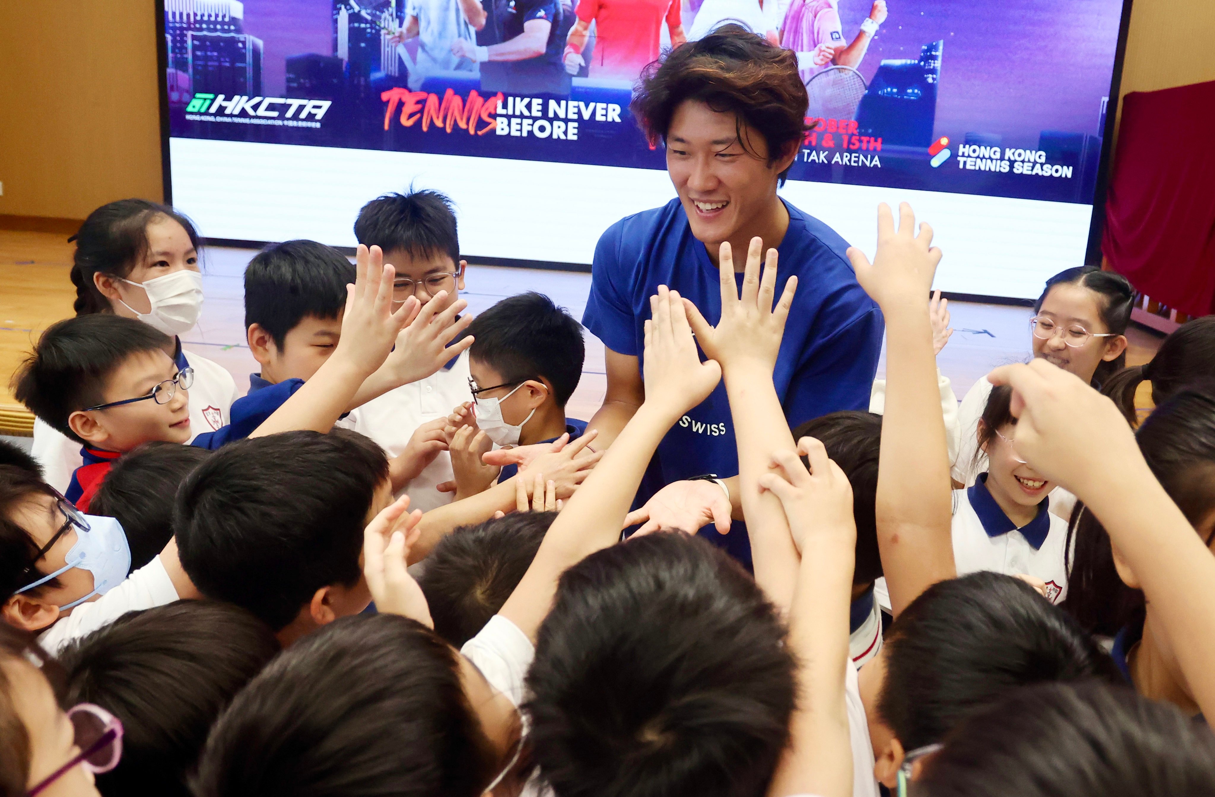 Tennis star Zhang Zhizhen meets pupils at S.K.H. St. Michael’s Primary School on Monday. Photo: Jonathan Wong