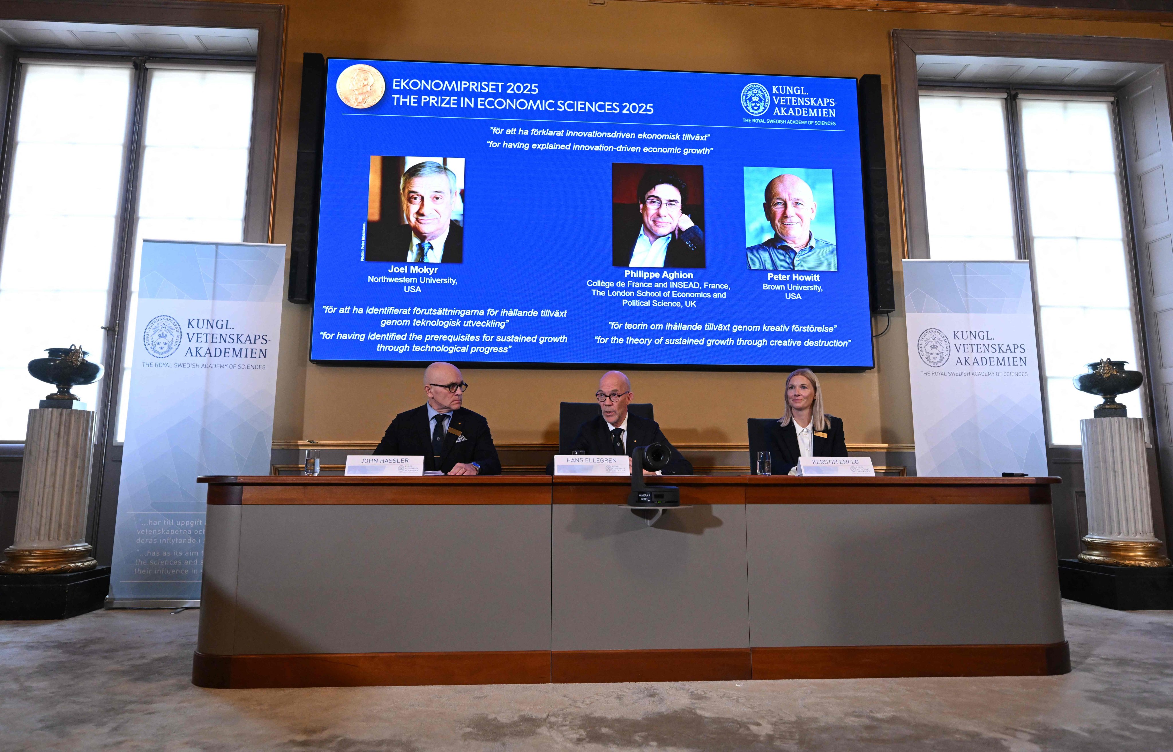A screen shows the winners of the 2025 Nobel Prize in Economics, at the Royal Swedish Academy of Sciences in Stockholm, Sweden, on Monday. Photo: AFP
