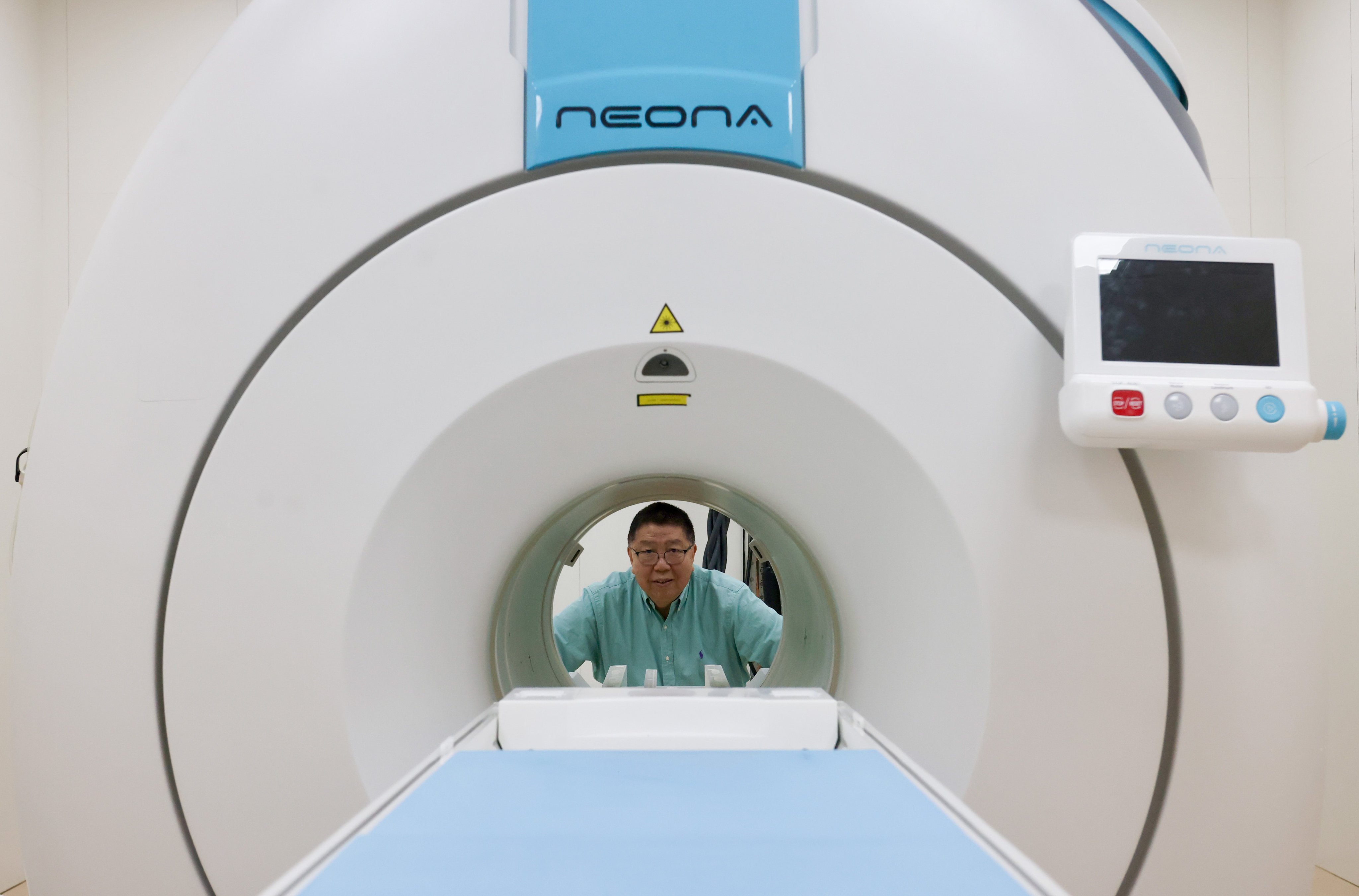 Ma Qiyuan, Time Medical Systems co-founder and chairman, pictured with one of the company’s scanners in its facility in Tai Po on October 6, 2025. Photo: Jonathan Wong