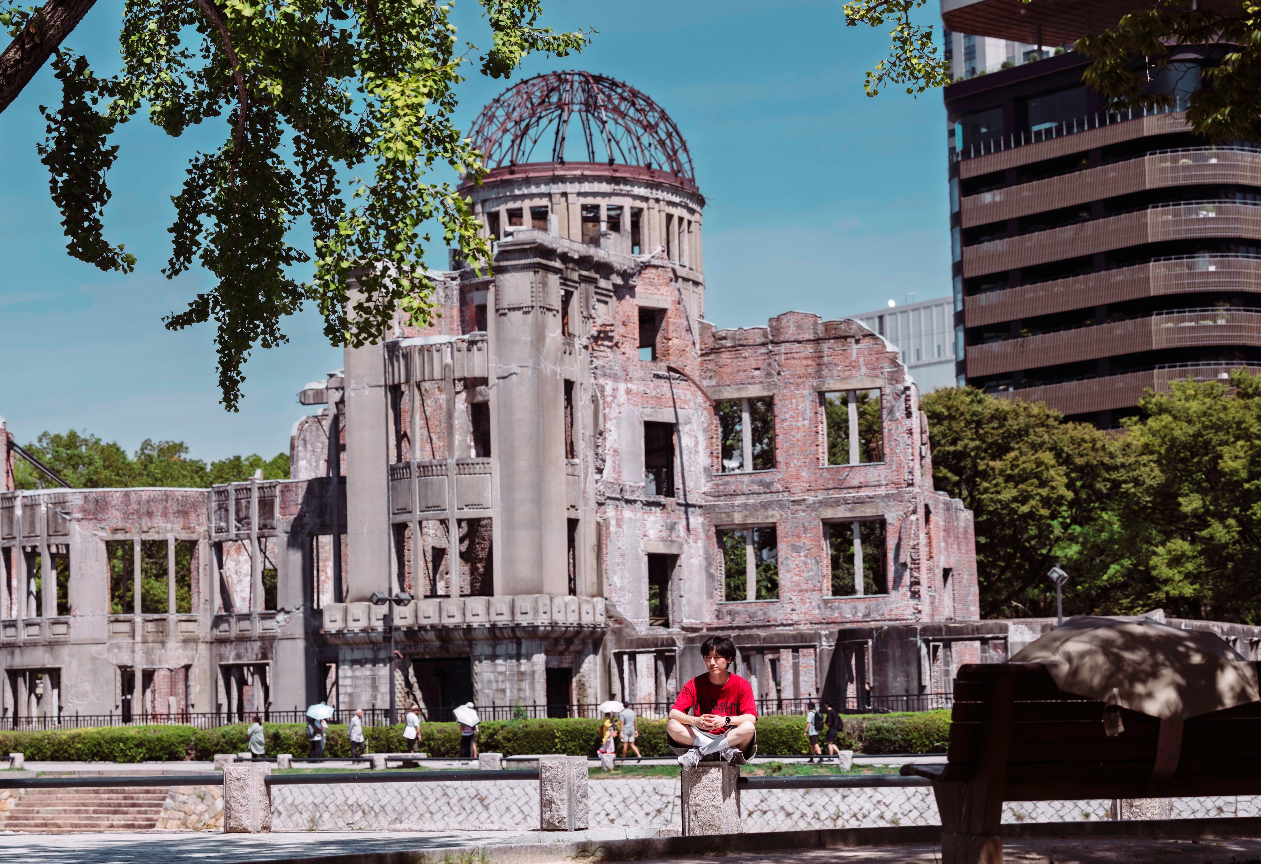 A person sits in front of the Atomic Bomb Dome memorial in Hiroshima, Japan, in September. Photo: EPA