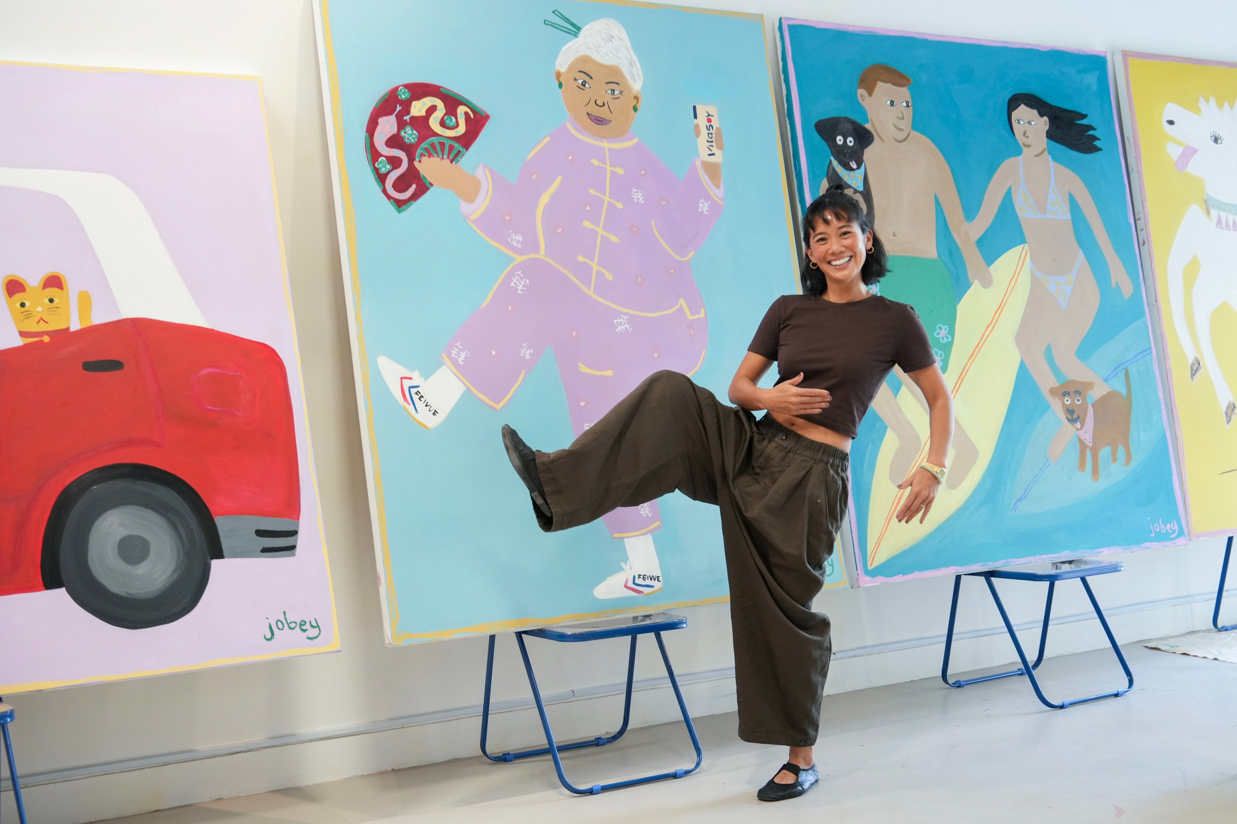 Hong Kong artist Joannah Hon poses with her paintings at her studio in Sai Ying Pun on October 7, 2025. Her art, which has gone viral on Instagram, showcases many of the city’s cultural icons. Photo: Sun Yeung