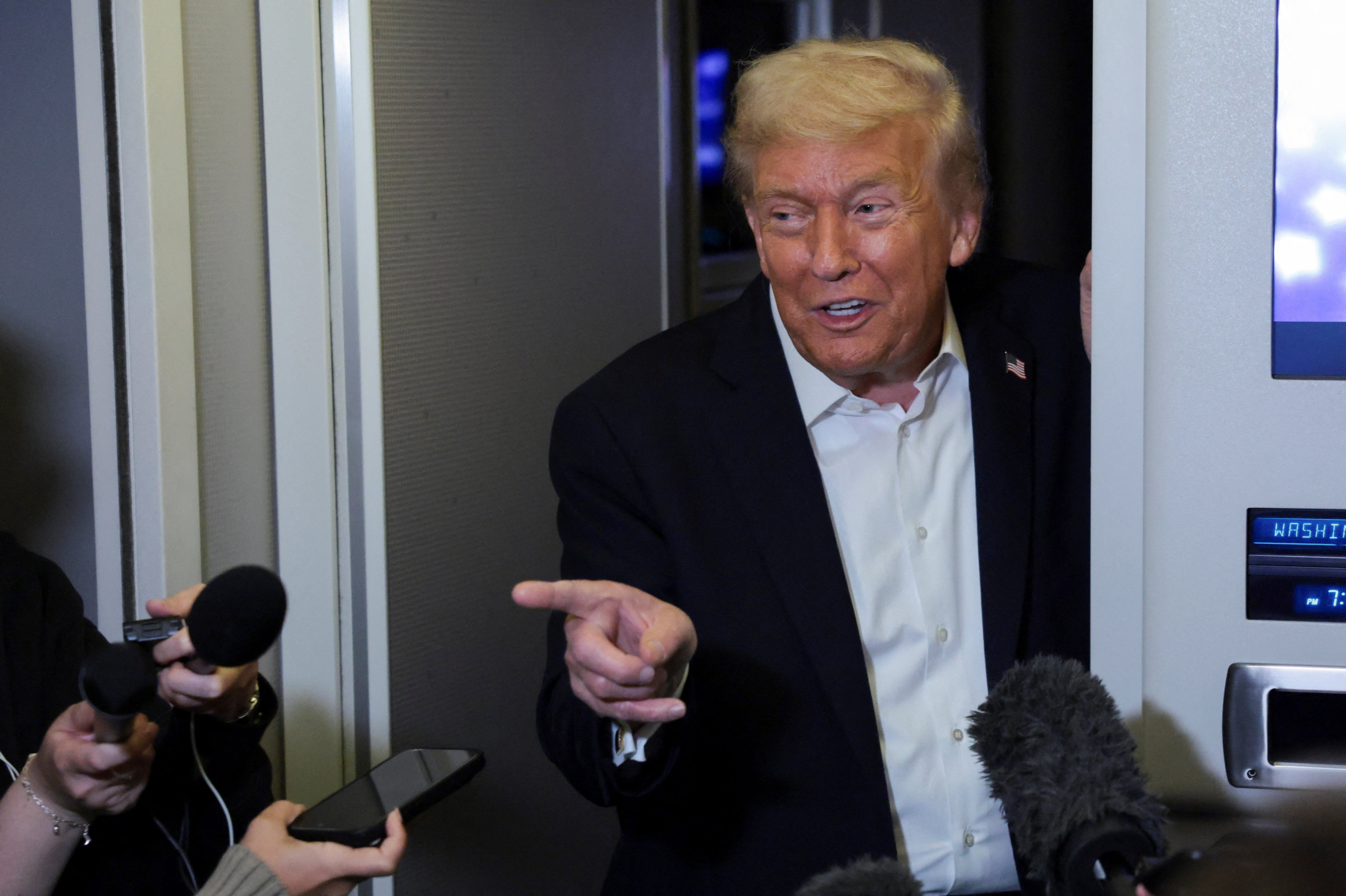 US President Donald Trump speaks to the media aboard Air Force One on Tuesday. Photo: Reuters