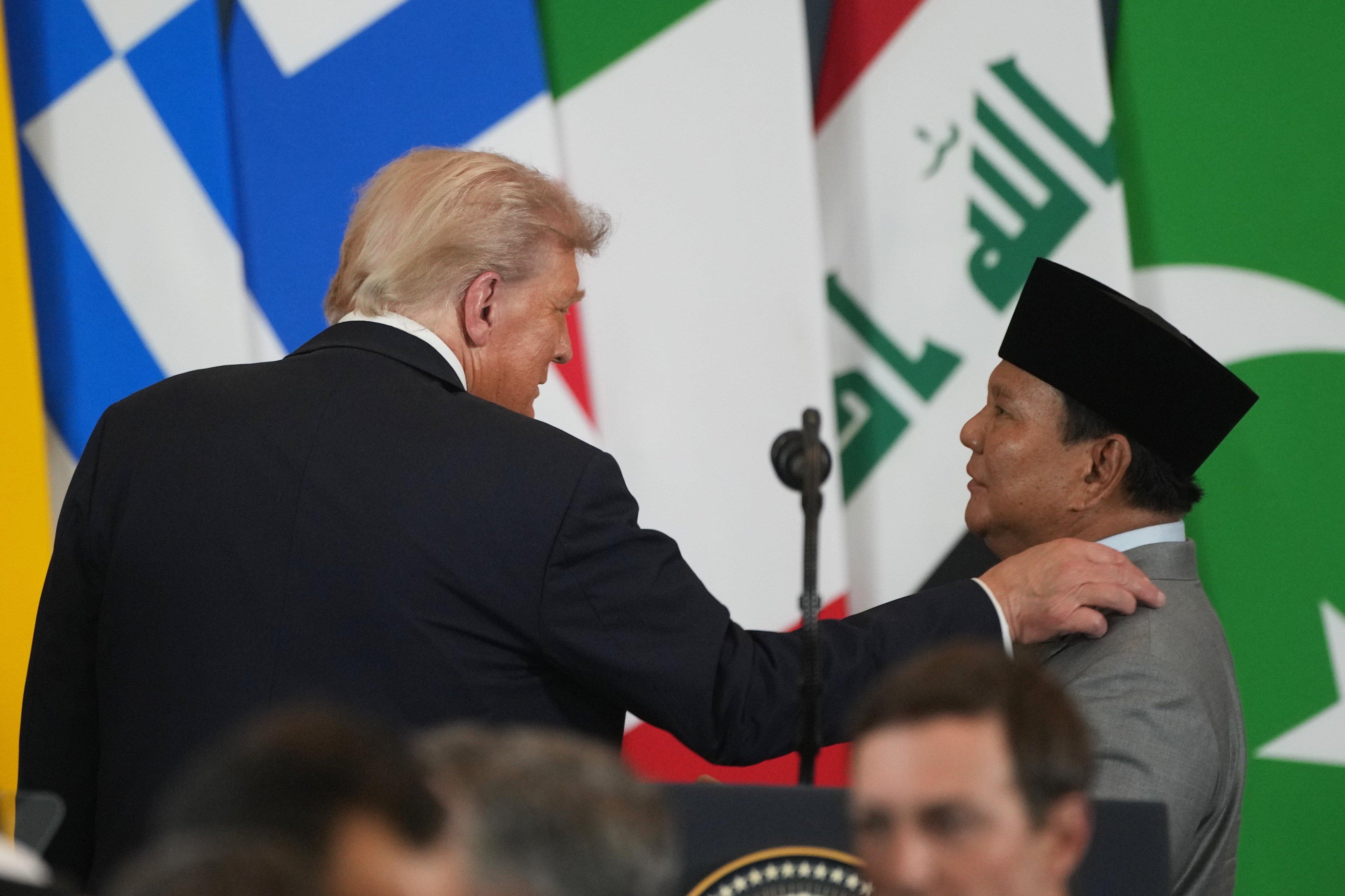 US President Donald Trump (left)  and Indonesian President Prabowo Subianto talk on the sidelines of the Gaza peace summit in Egypt, not realising both are still miked up, on Monday. Photo: AP