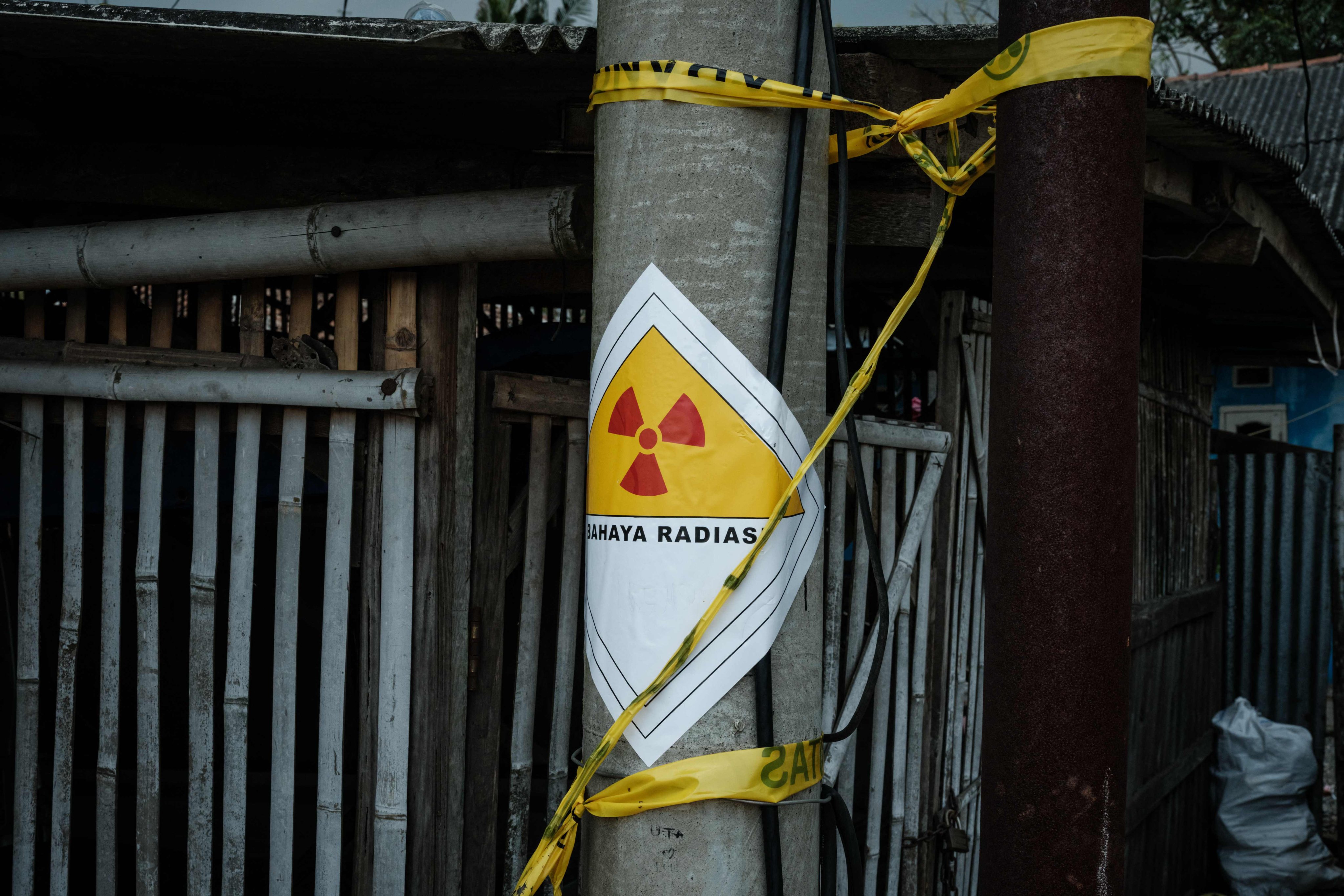 A warning sticker labelled “Danger Radiation” on a power pole next to the Modern Cikande Industrial Estate, where the radioactive isotope Caesium 137 was detected, in Sukatani, Banten, Indonesia. Photo: AFP