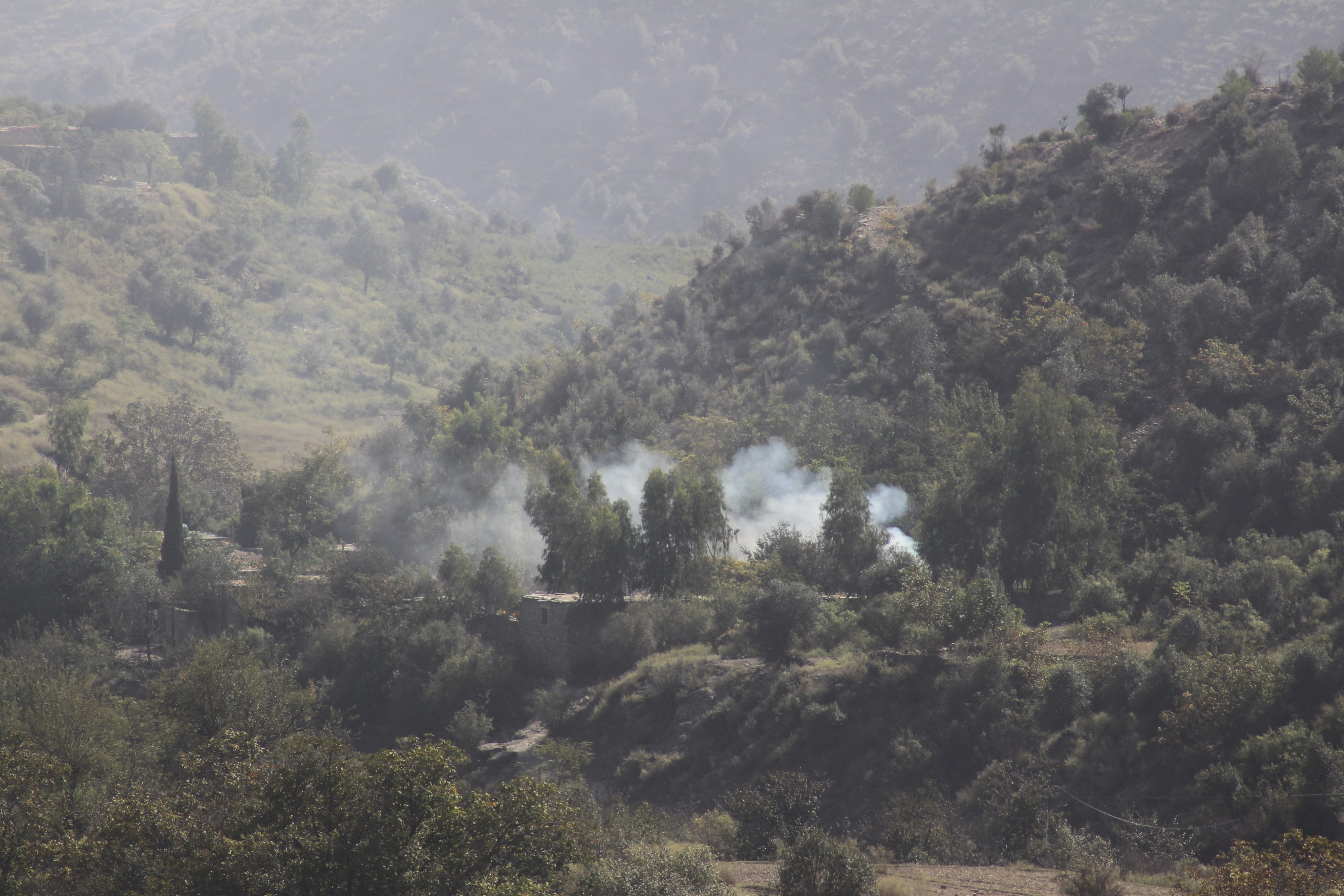 Smoke rises from a hillside following overnight clashes between Afghan and Pakistani forces along the border on Sunday. Photo: AP