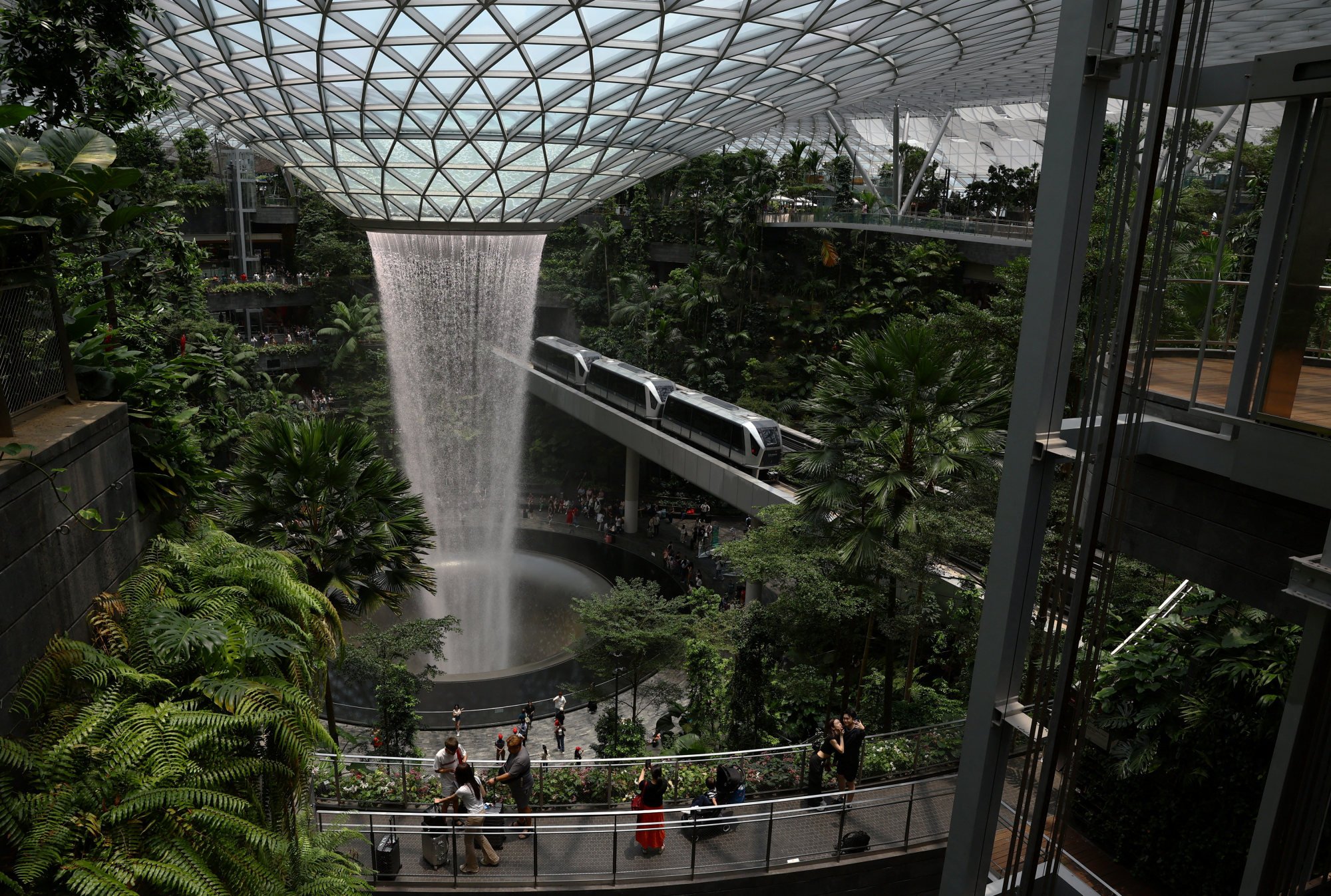 Changi Airport features numerous amenities not typically found at other airports, including an extensive shopping centre, two cinemas, an indoor rock-climbing wall, and an impressive indoor waterfall, above. Photo: Reuters/Edgar Su Changi Airport features numerous amenities not typically found at other airports, including an extensive shopping centre, two cinemas, an indoor rock-climbing wall, and an impressive indoor waterfall, above. Photo: Reuters/Edgar Su