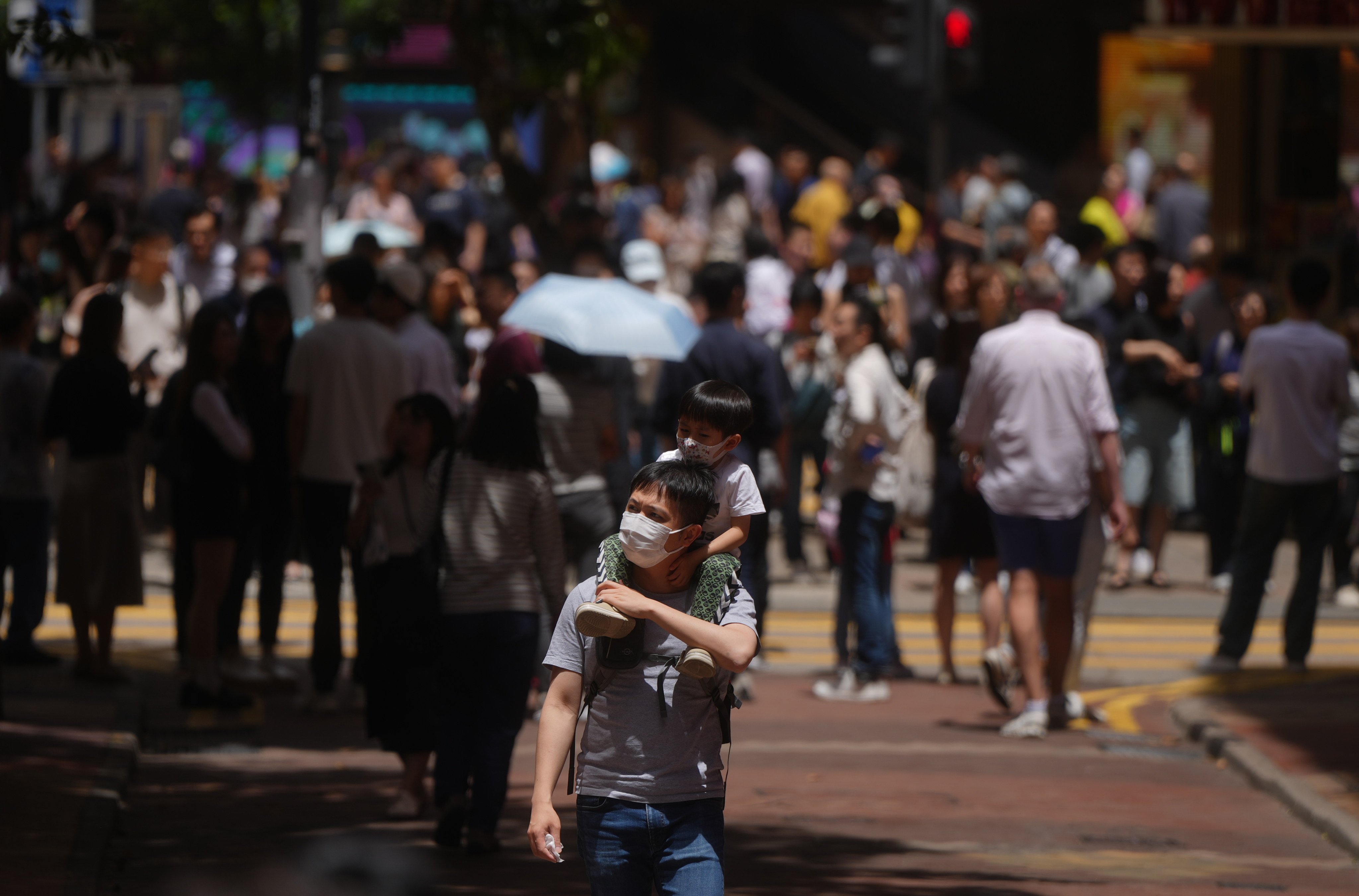 Pedestrians wearing face masks. An expert has said the number of flu cases has not yet peaked and that the summer season may last at least until November. Photo: Sam Tsang