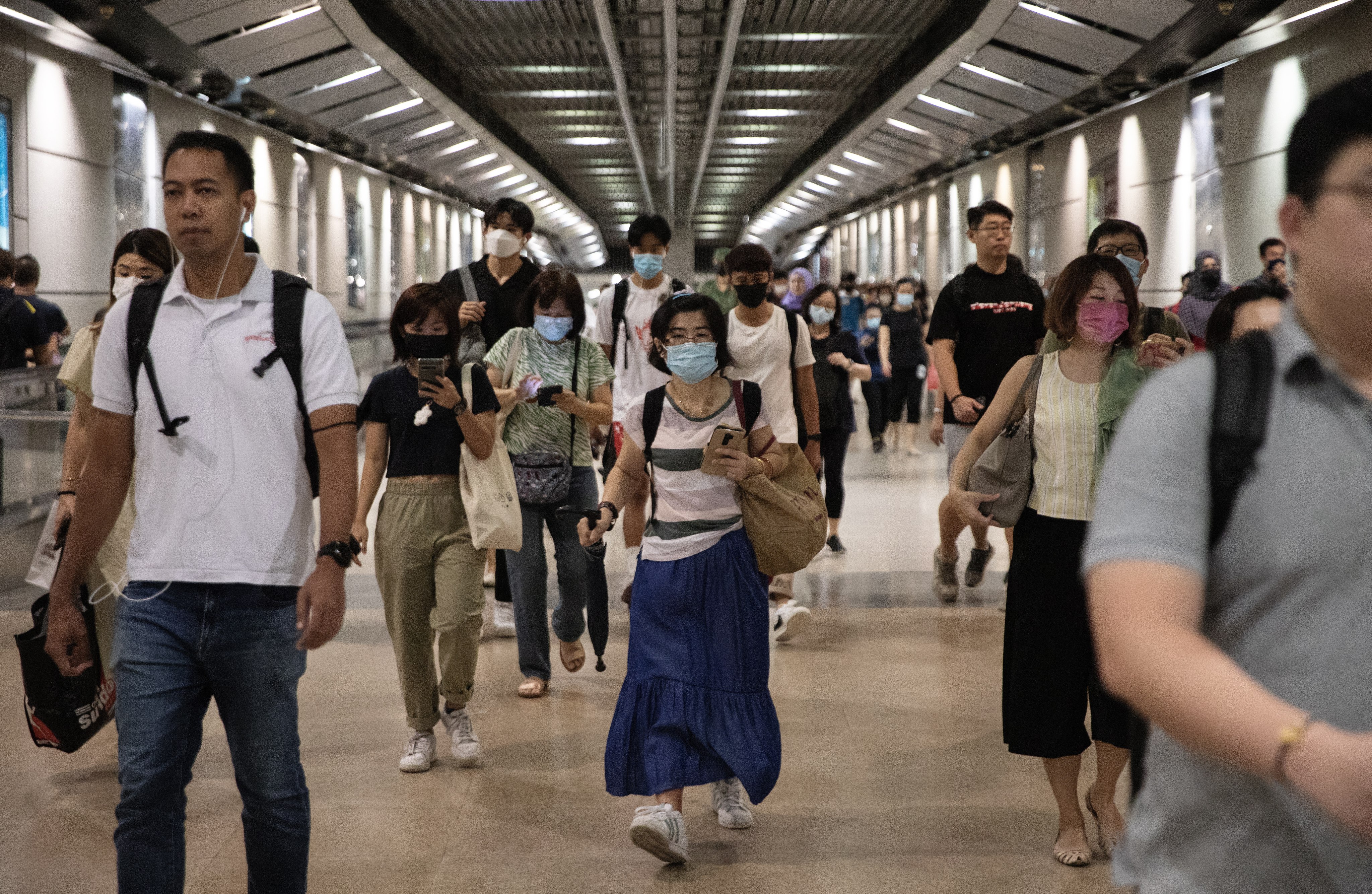 People walk in an underground MRT train station in Singapore. The government reiterates its stance in parliament on Tuesday against the politics of race and religion. Photo: EPA-EFE