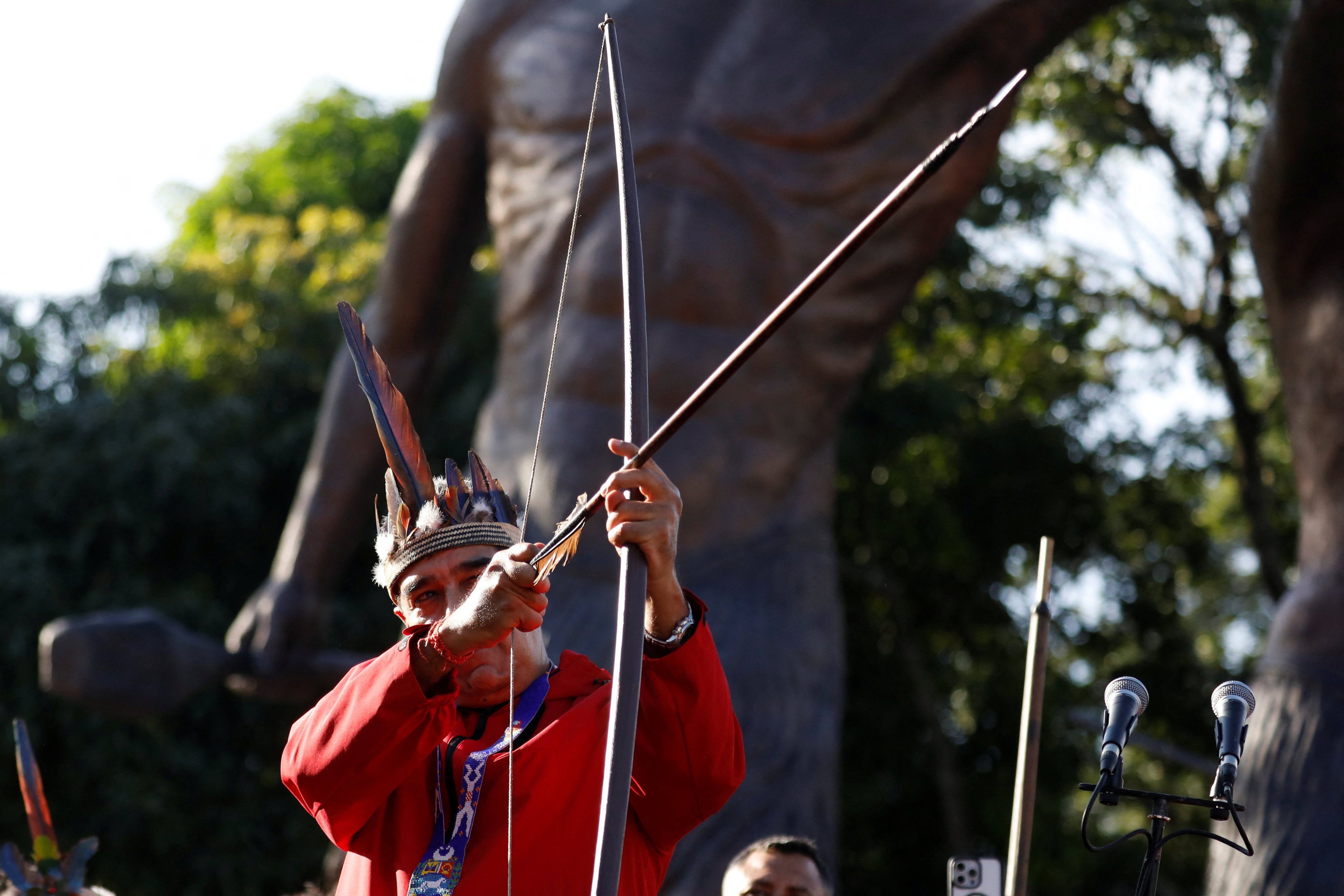 President Nicolas Maduro aims a bow and arrow during Indigenous Day. Photo: AP