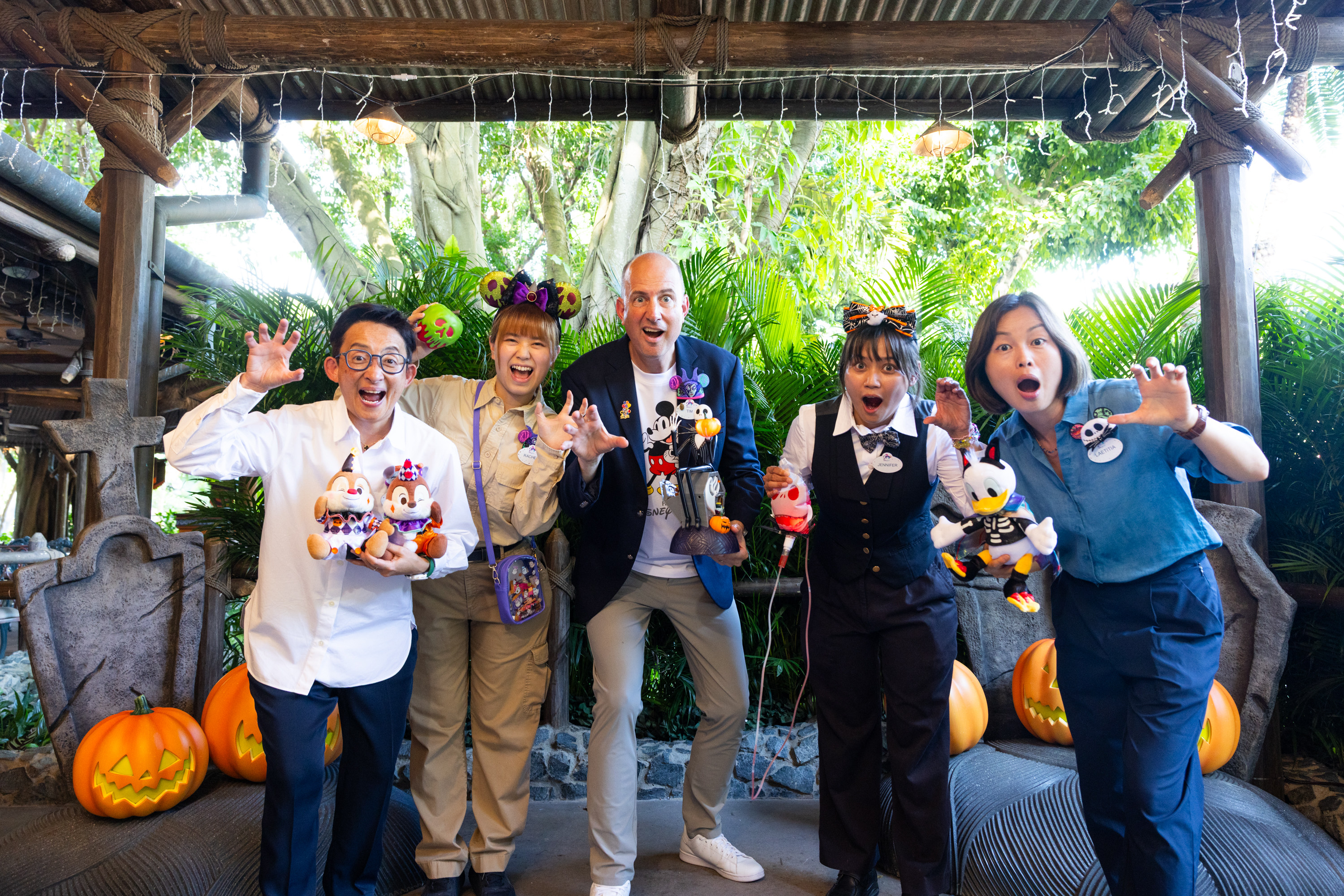 Tim Sypko (centre), Hong Kong Disneyland Resort’s senior vice-president of operations, showcases some of its Halloween merchandise alongside entertainment operations director Virginia Sung (far left), entertainment producer Laetitia Lee (far right) and frontline staff working in merchandise and food and beverage.