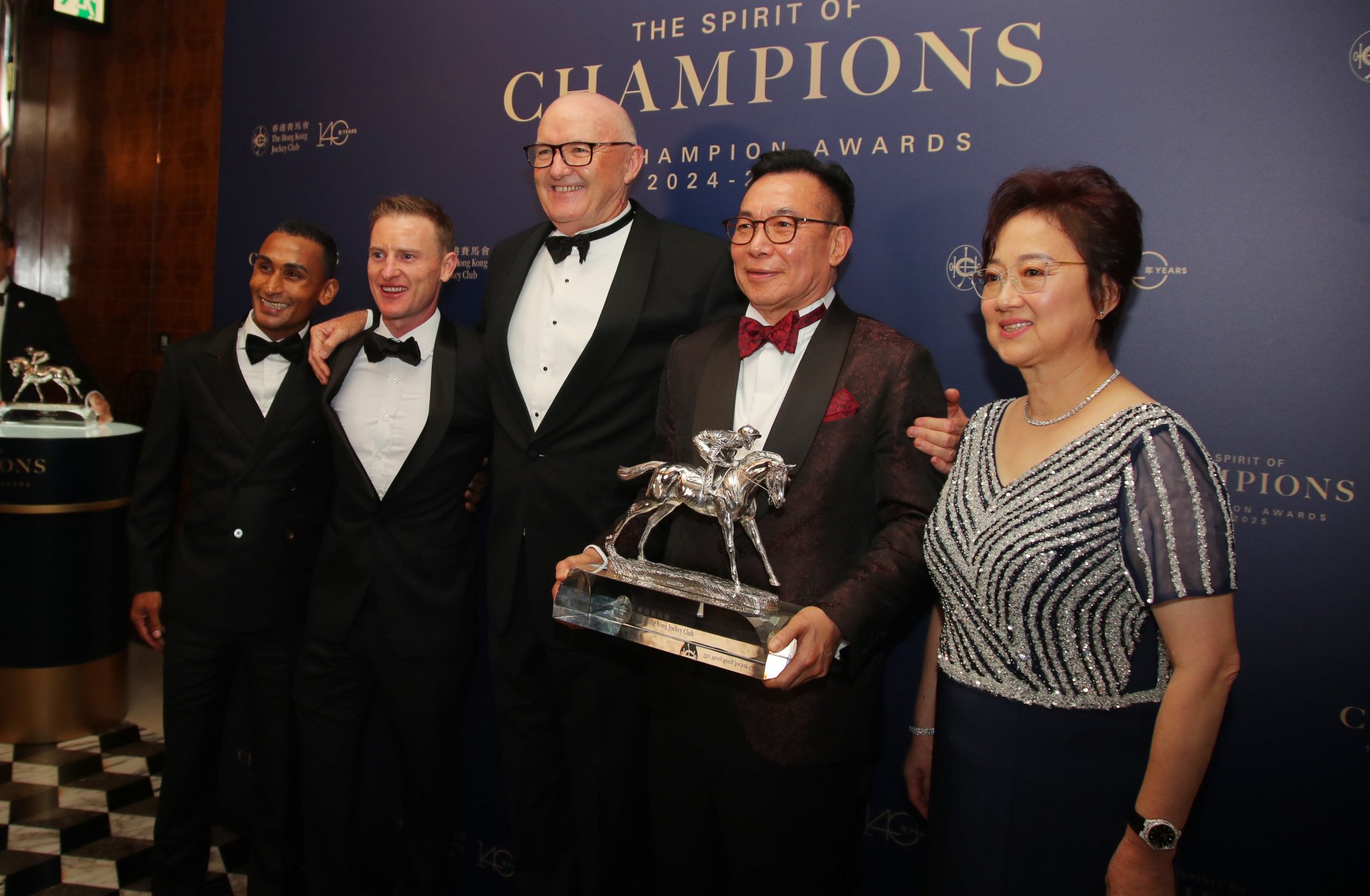 Jockeys Karis Teetan and Zac Purton, trainer David Hayes and owners Leung Shek-kong and Wong Choi-ha accept Ka Ying Rising’s 2024-25 Horse of the Year spoils.